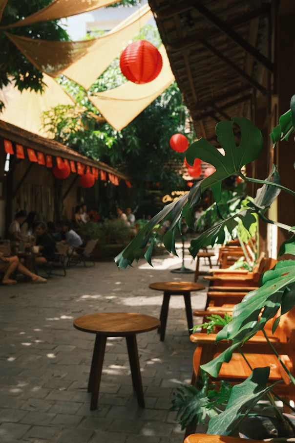 Outdoor cafe with wooden furniture and red lanterns