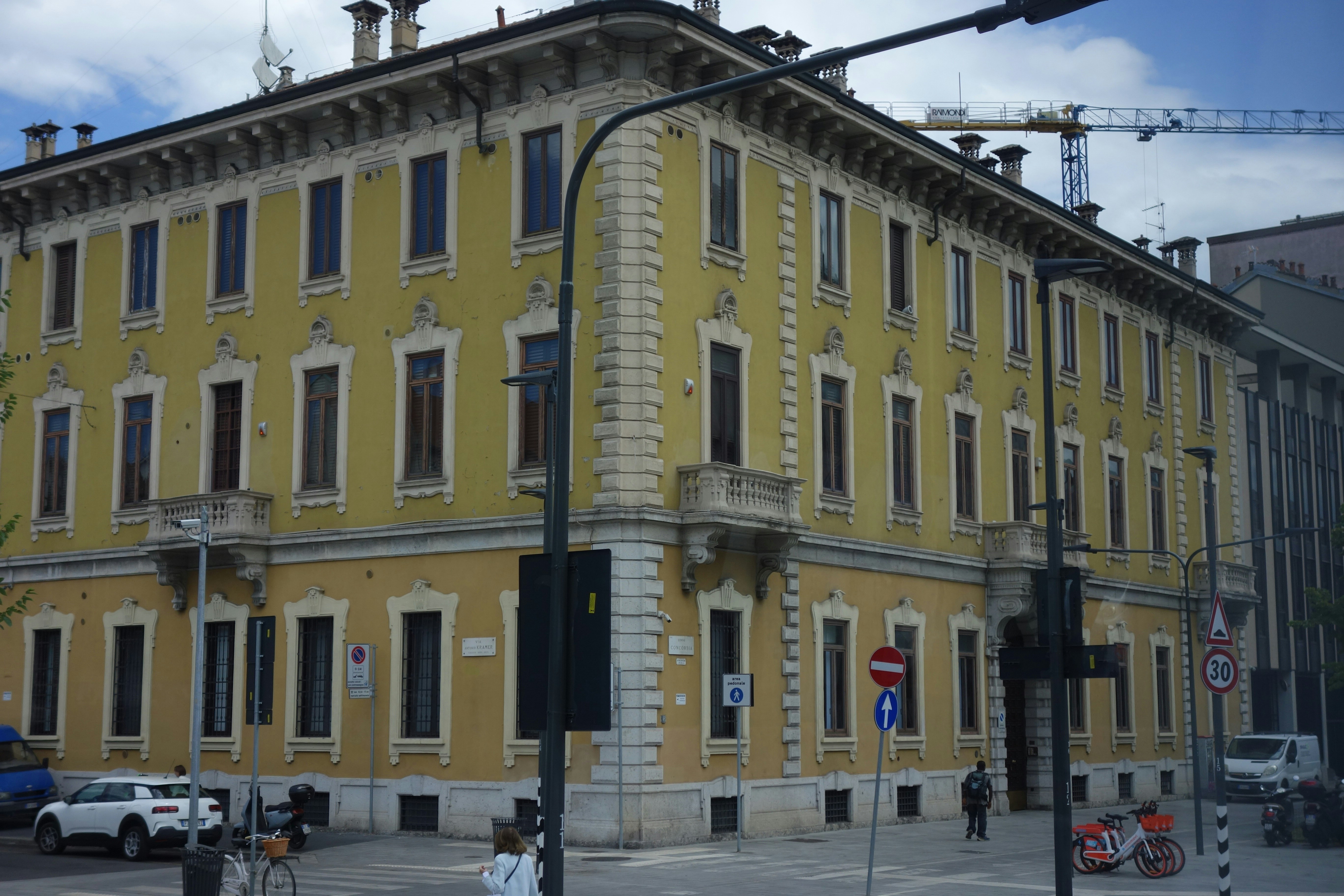 Yellow building with many windows and ornate details.
