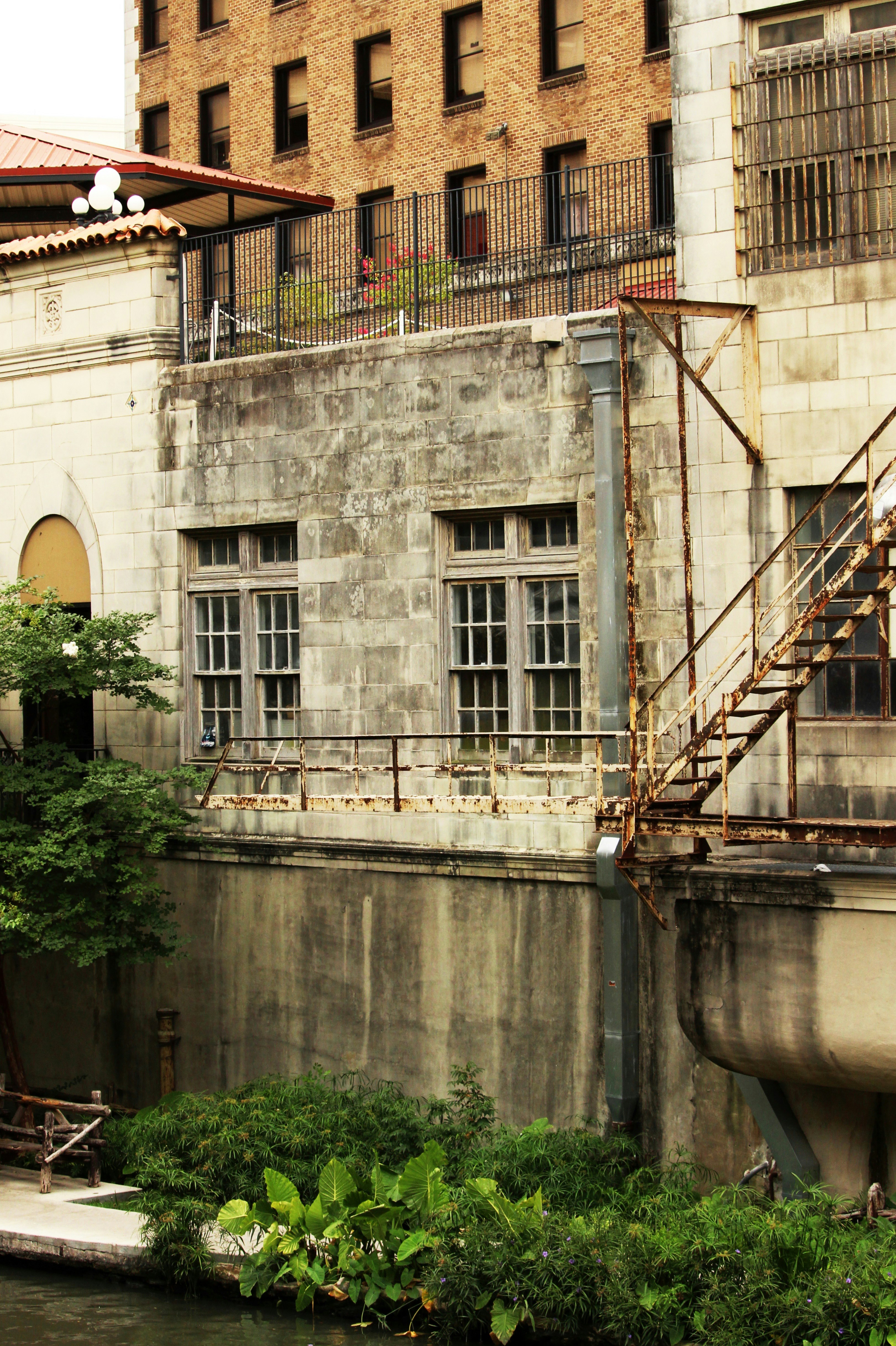 Old building with weathered stone and rusty stairs.