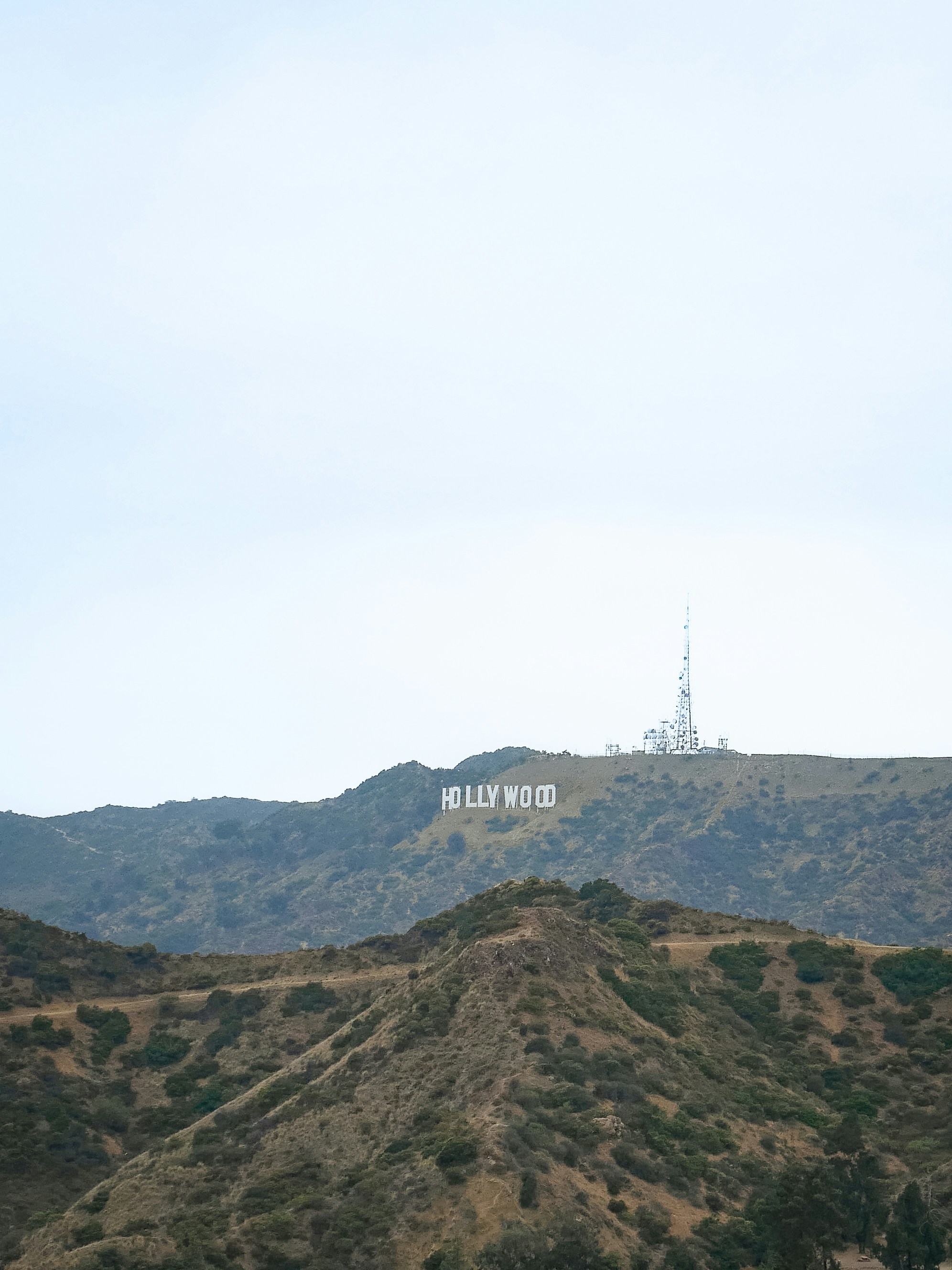 Hollywood sign on a distant hillside undercast hill