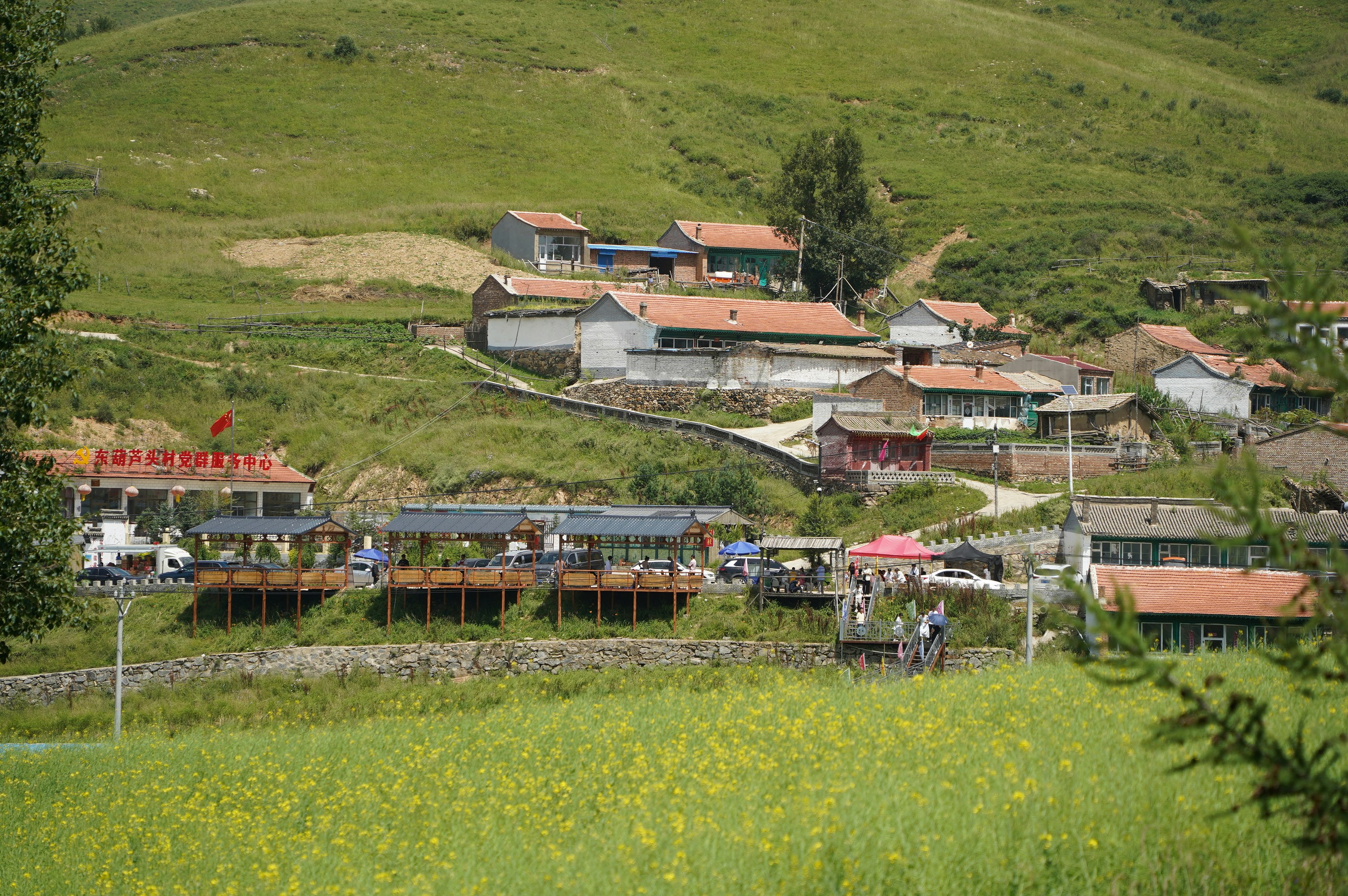Rural village nestled in a green, rolling landscape.