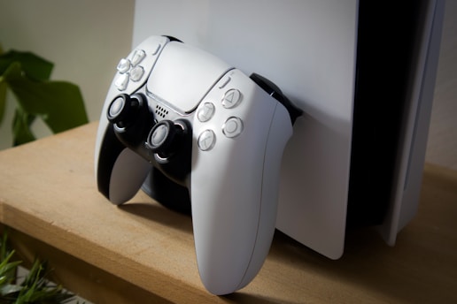 White game controller resting on a console