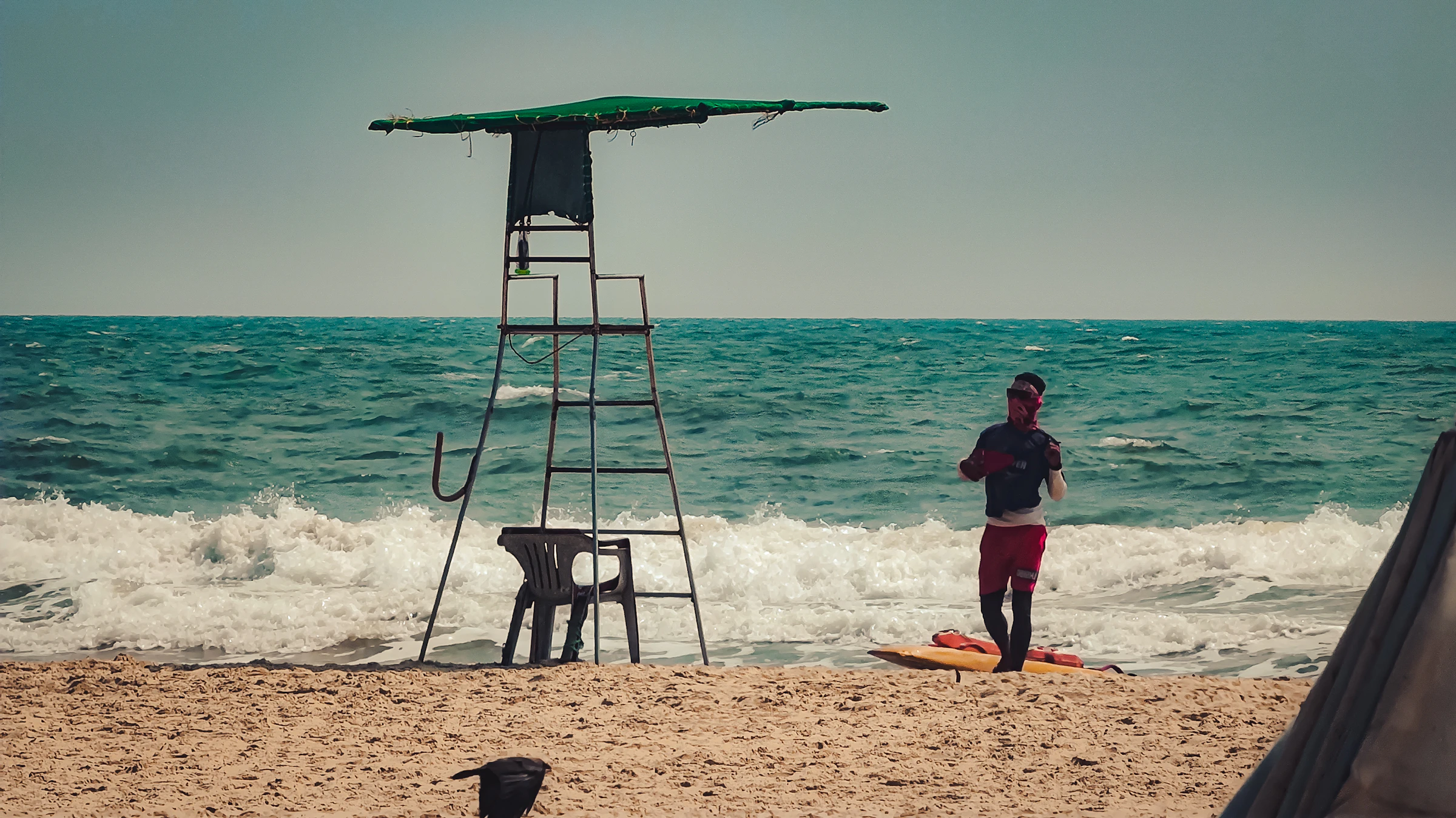 Lifeguard working beside the ocean with water-safety equipment