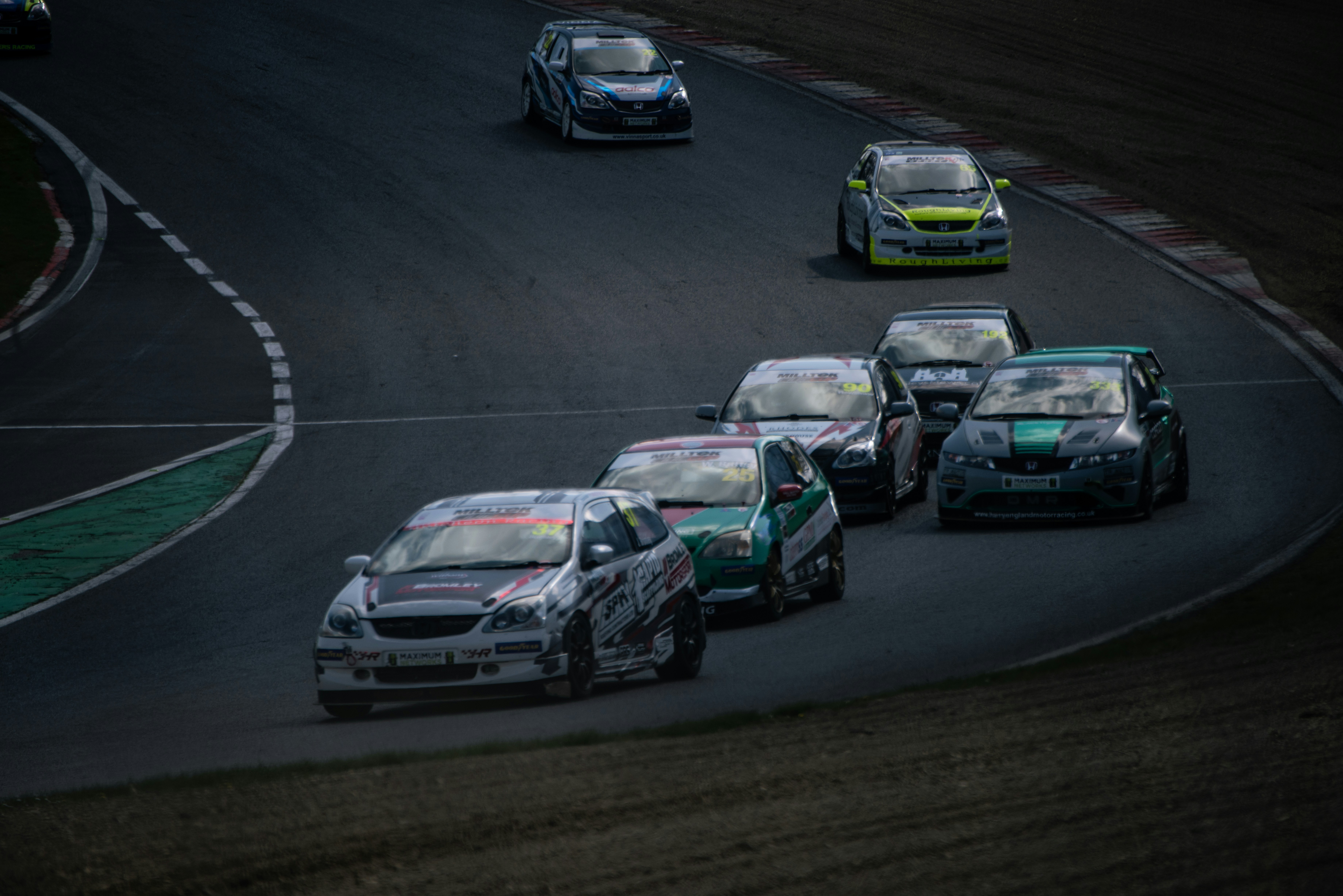 Race cars speeding around a track corner