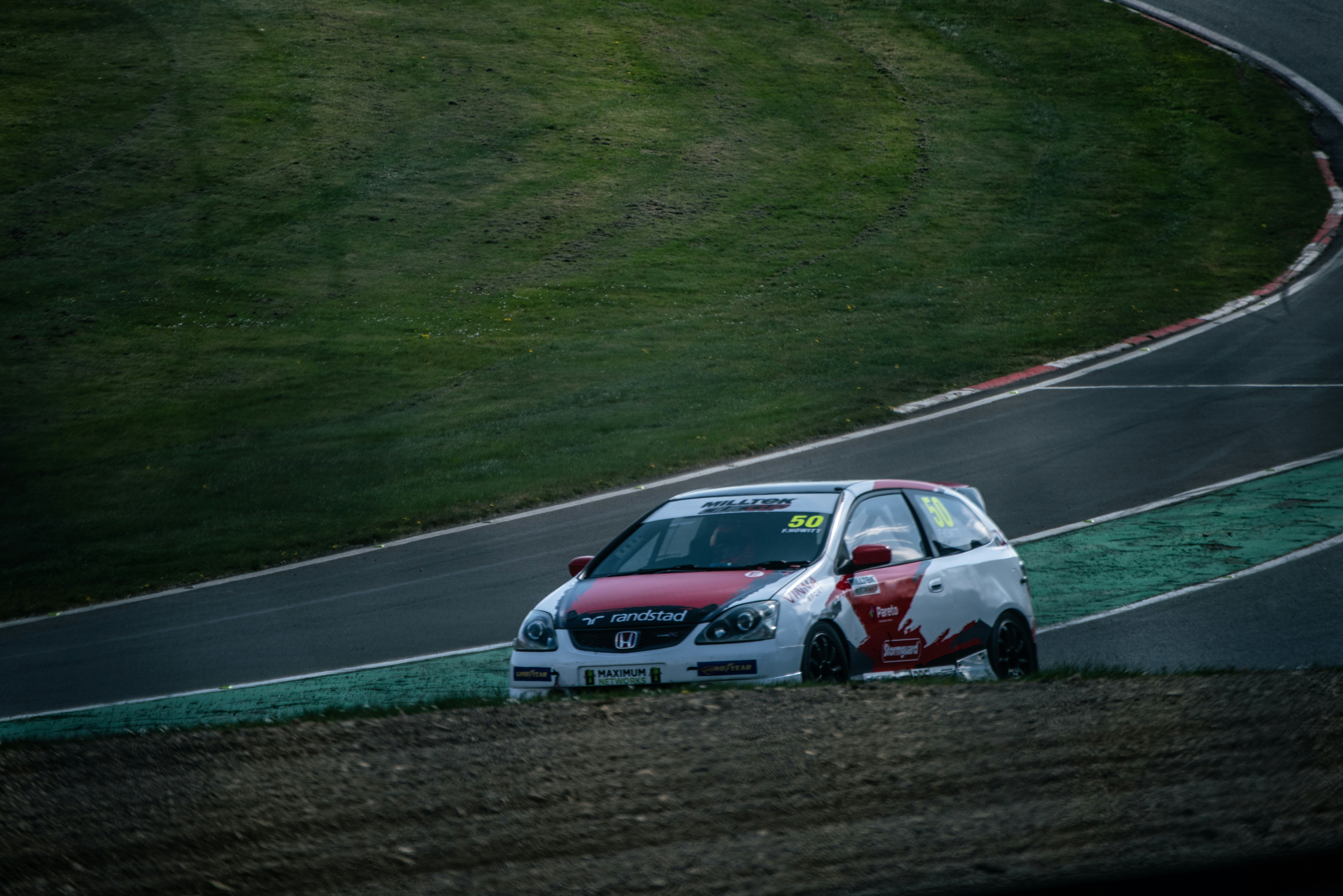 Race car veers off track on a sunny day