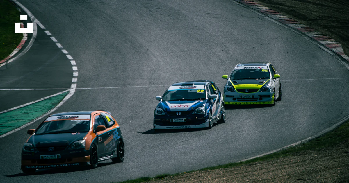 Three race cars competing on a winding track. photo – Free Cars Image ...