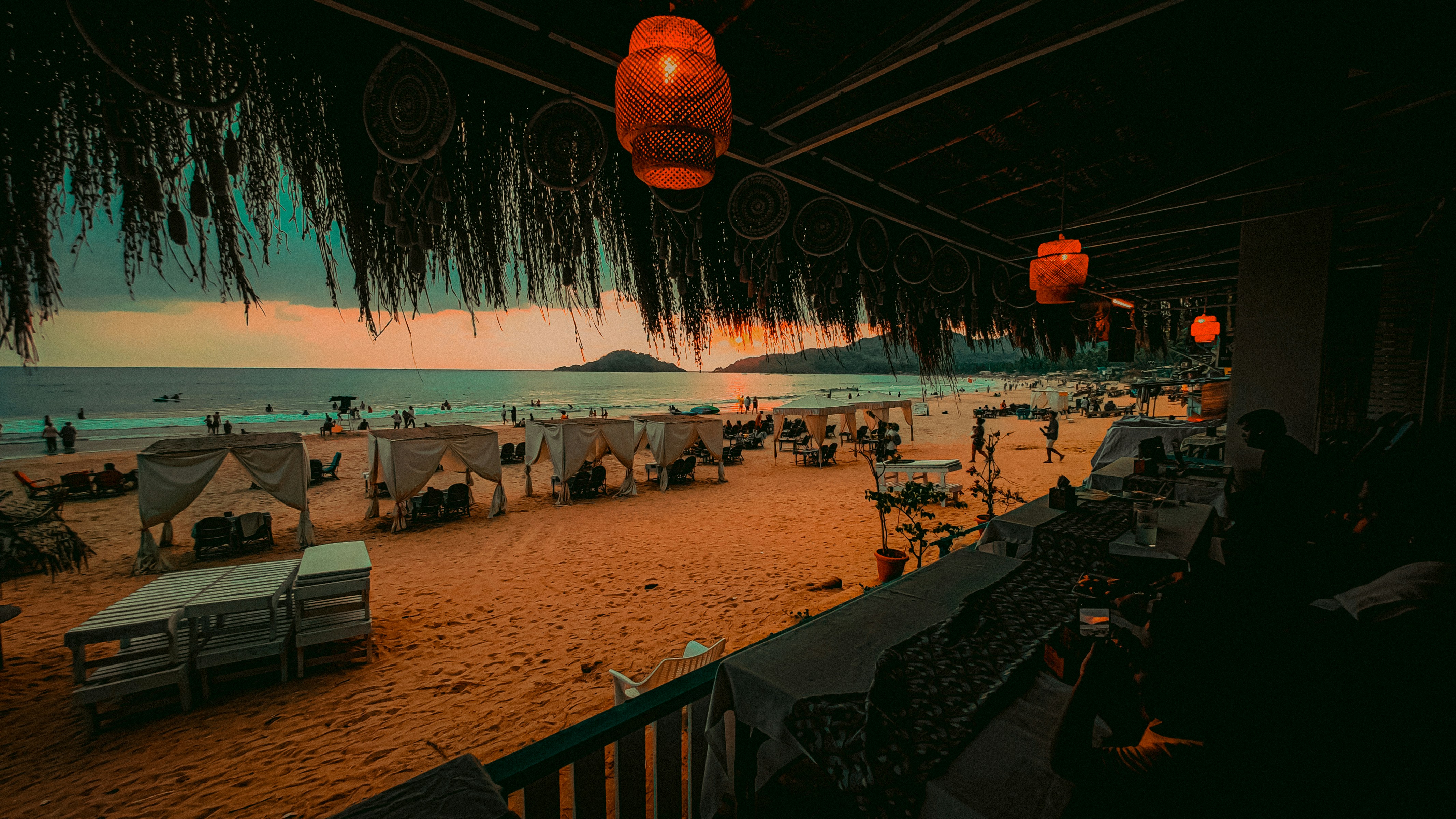 Beachside resort with thatched umbrellas and ocean view.