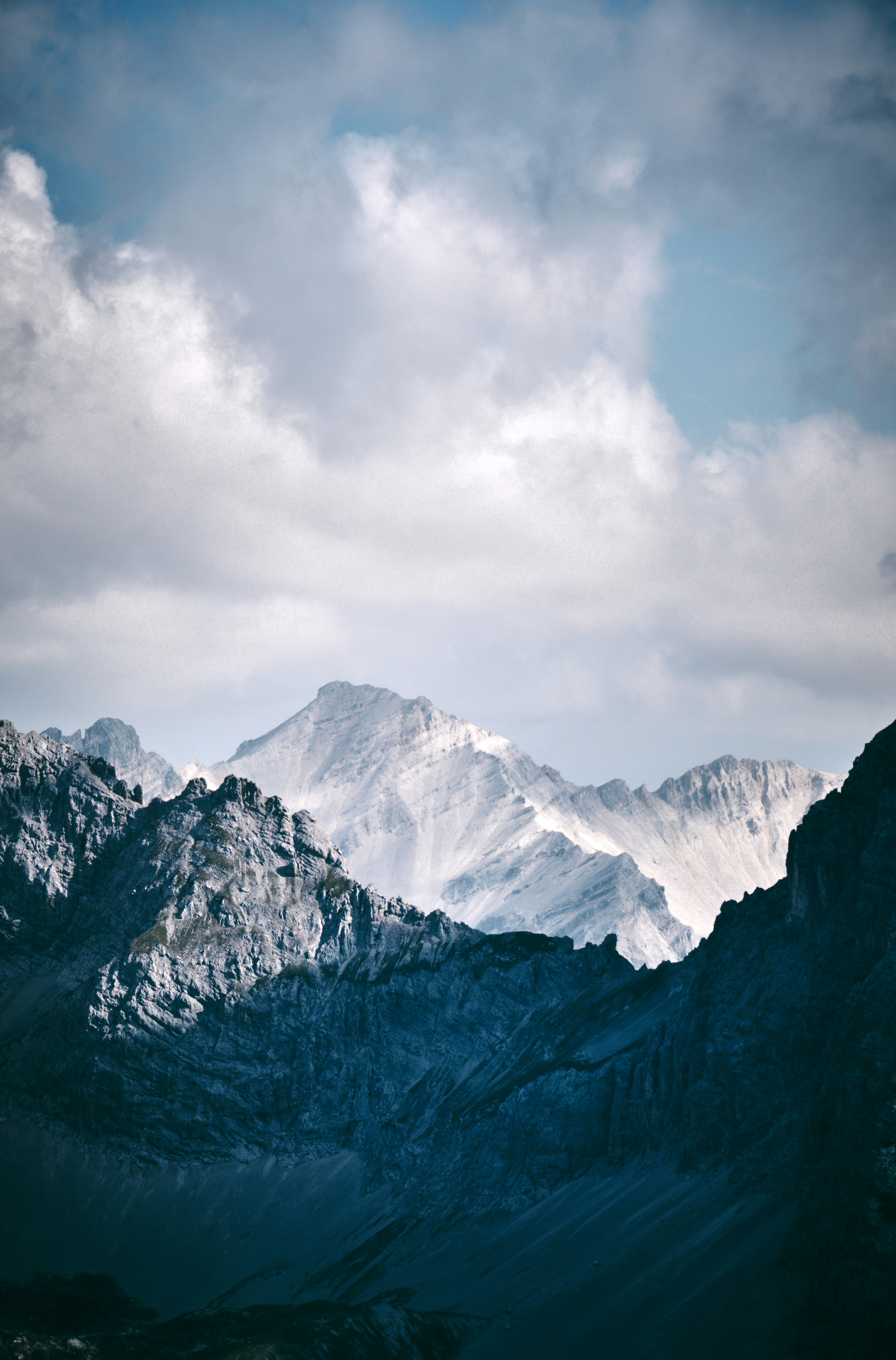 Snow-covered mountains under a cloudy sky