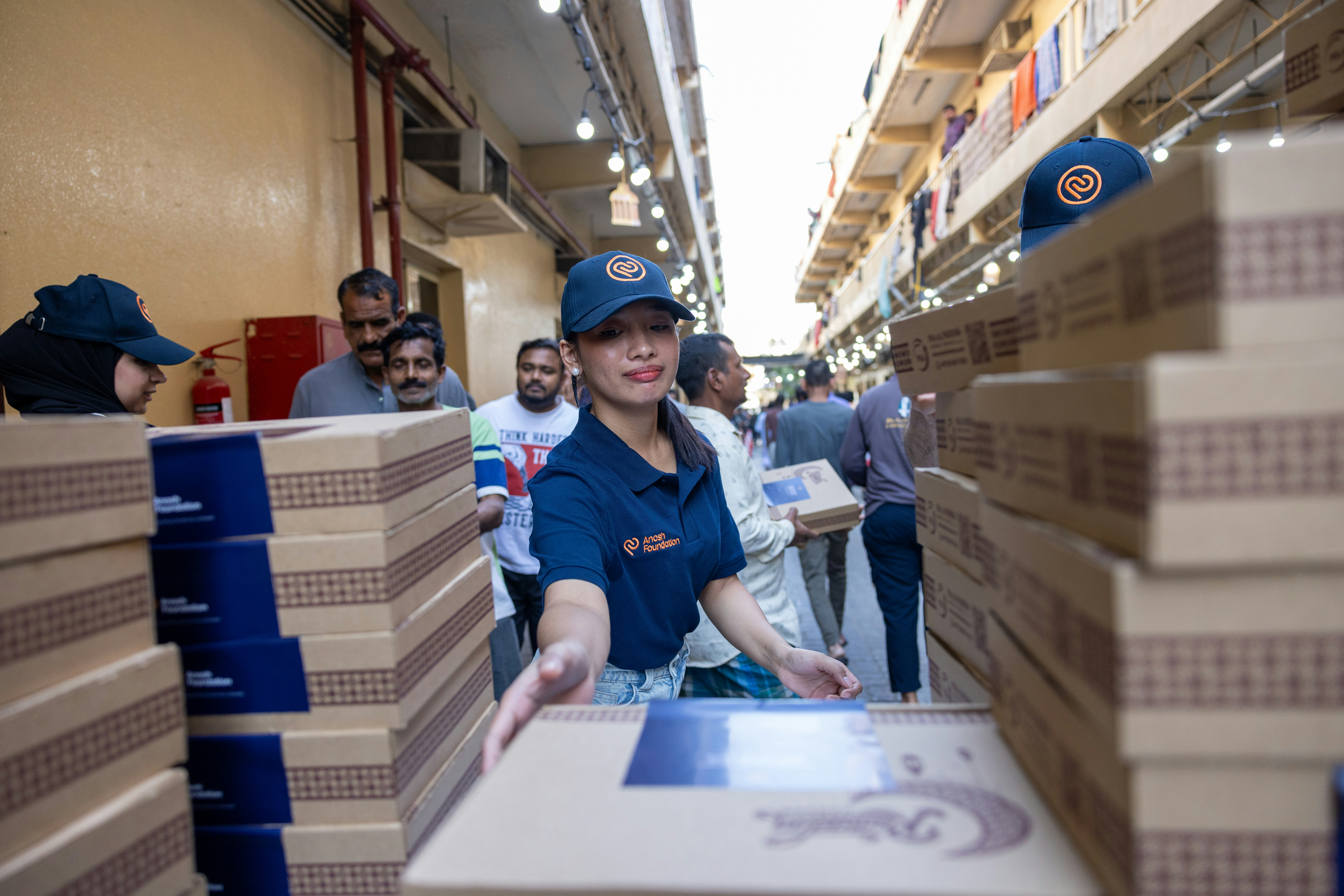 Woman in uniform handling boxes in a warehouse