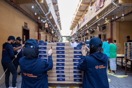 Volunteers stacking boxes of food for distribution