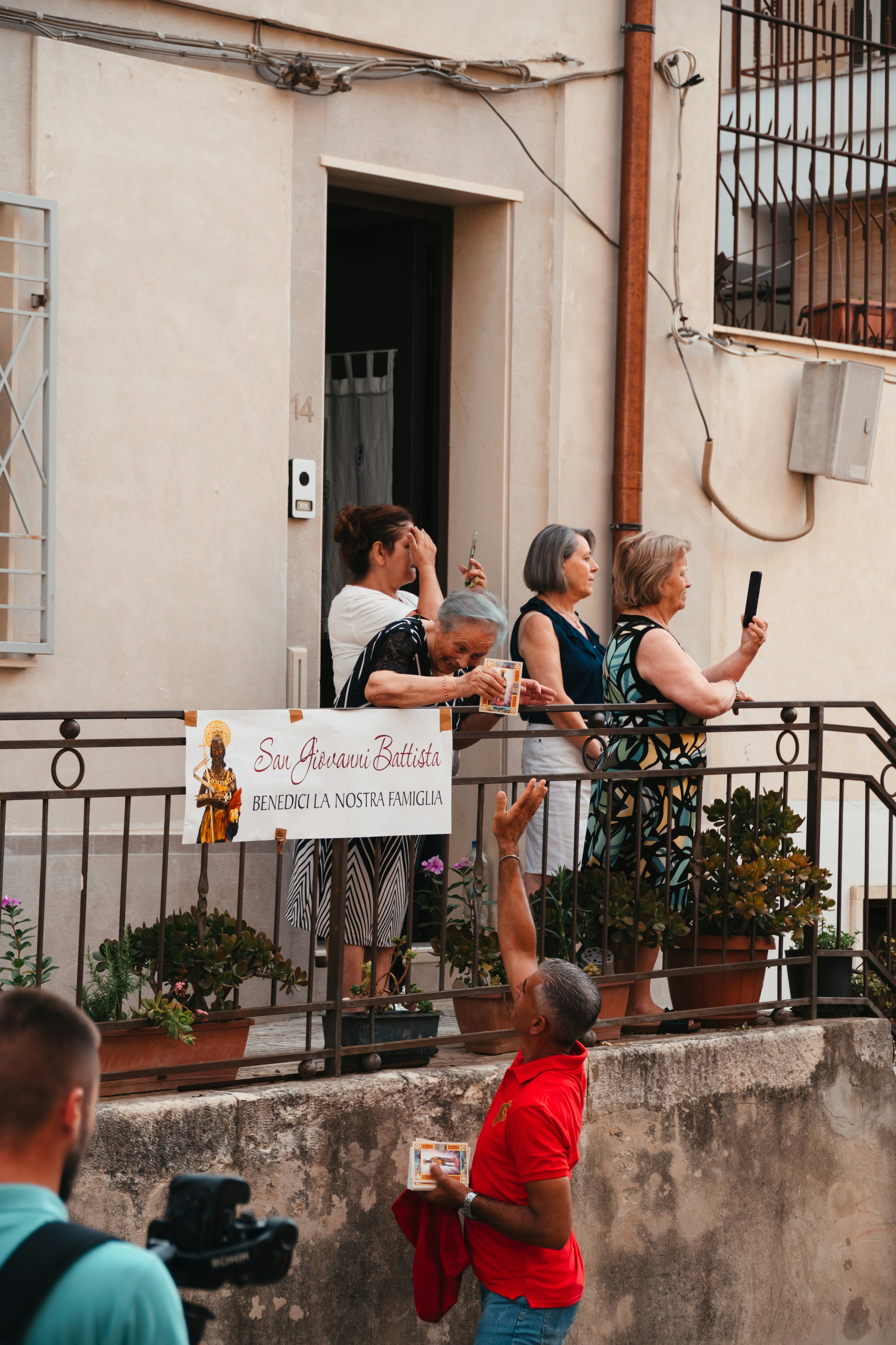 People watching a procession from a balcony