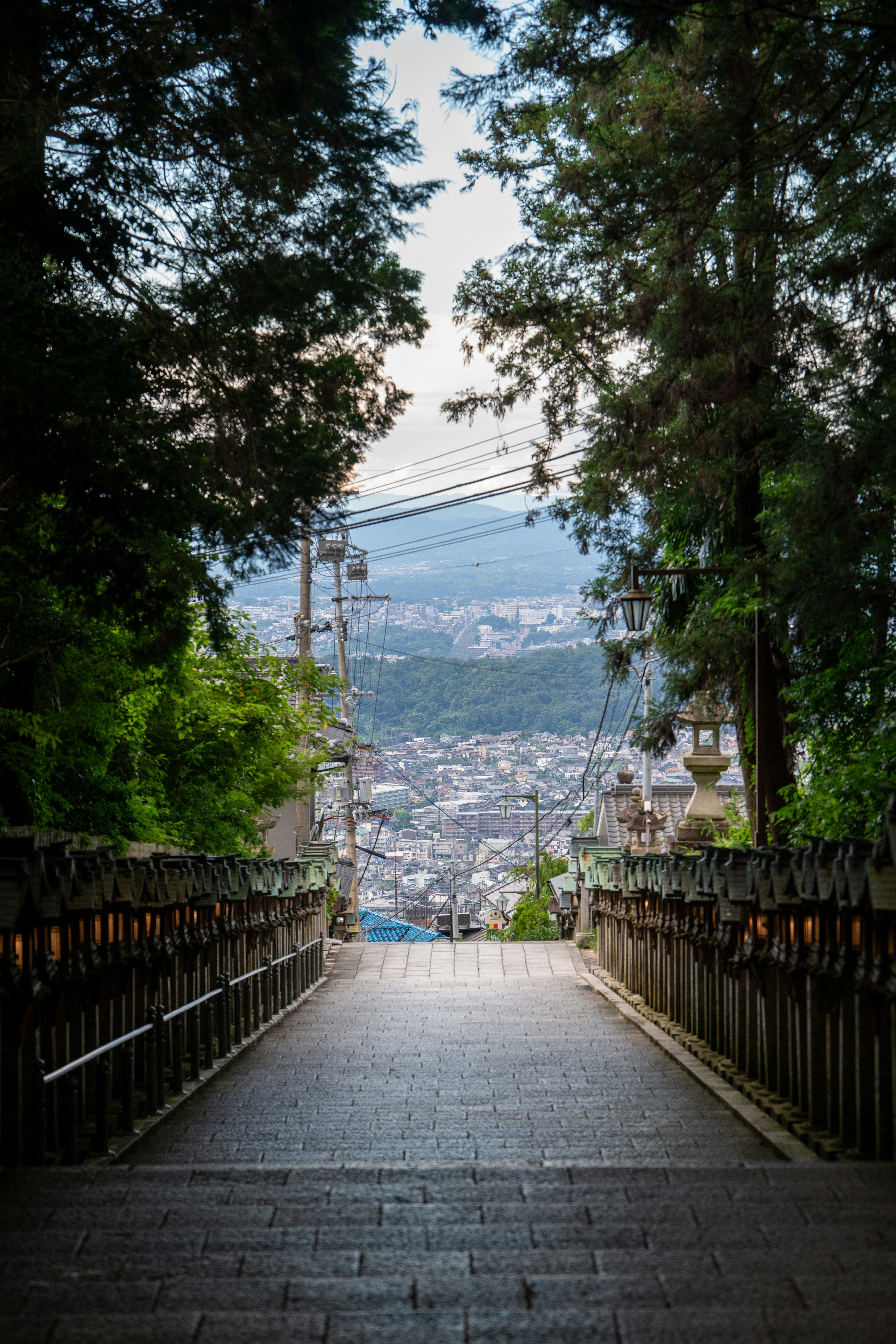 Stone staircase leading down to a distant city view.