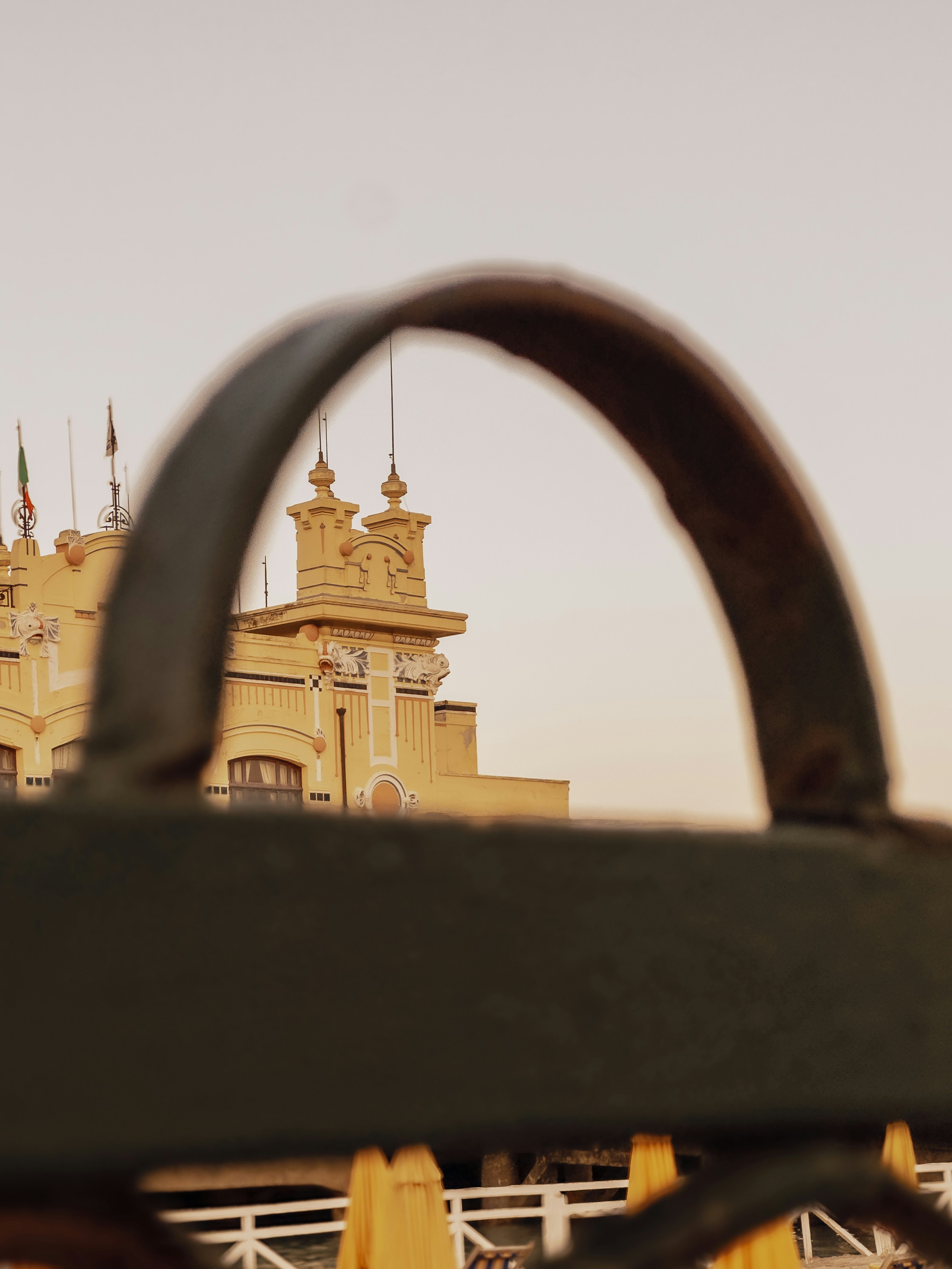 Yellow building seen through a dark archway