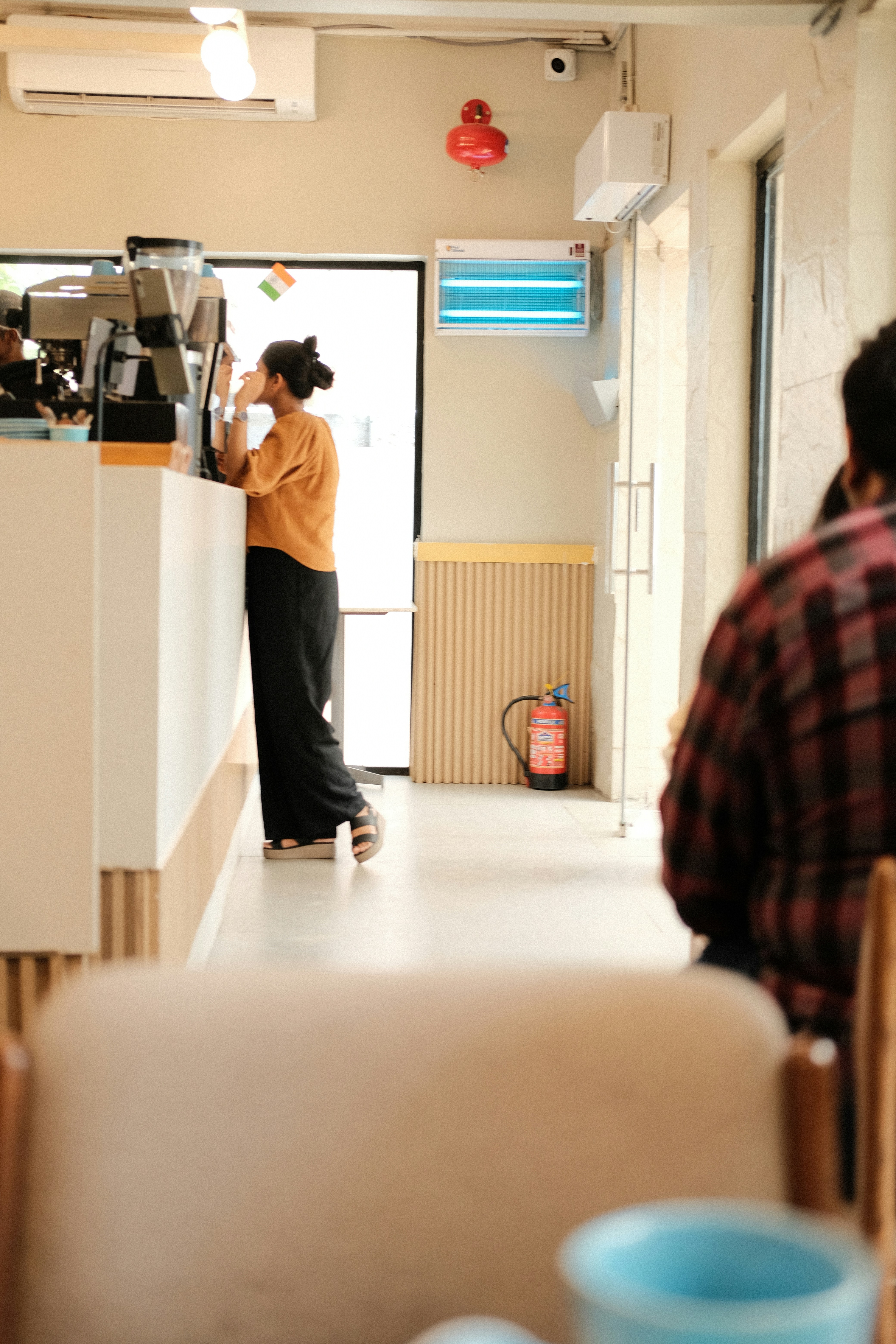 Woman ordering coffee at a cafe counter