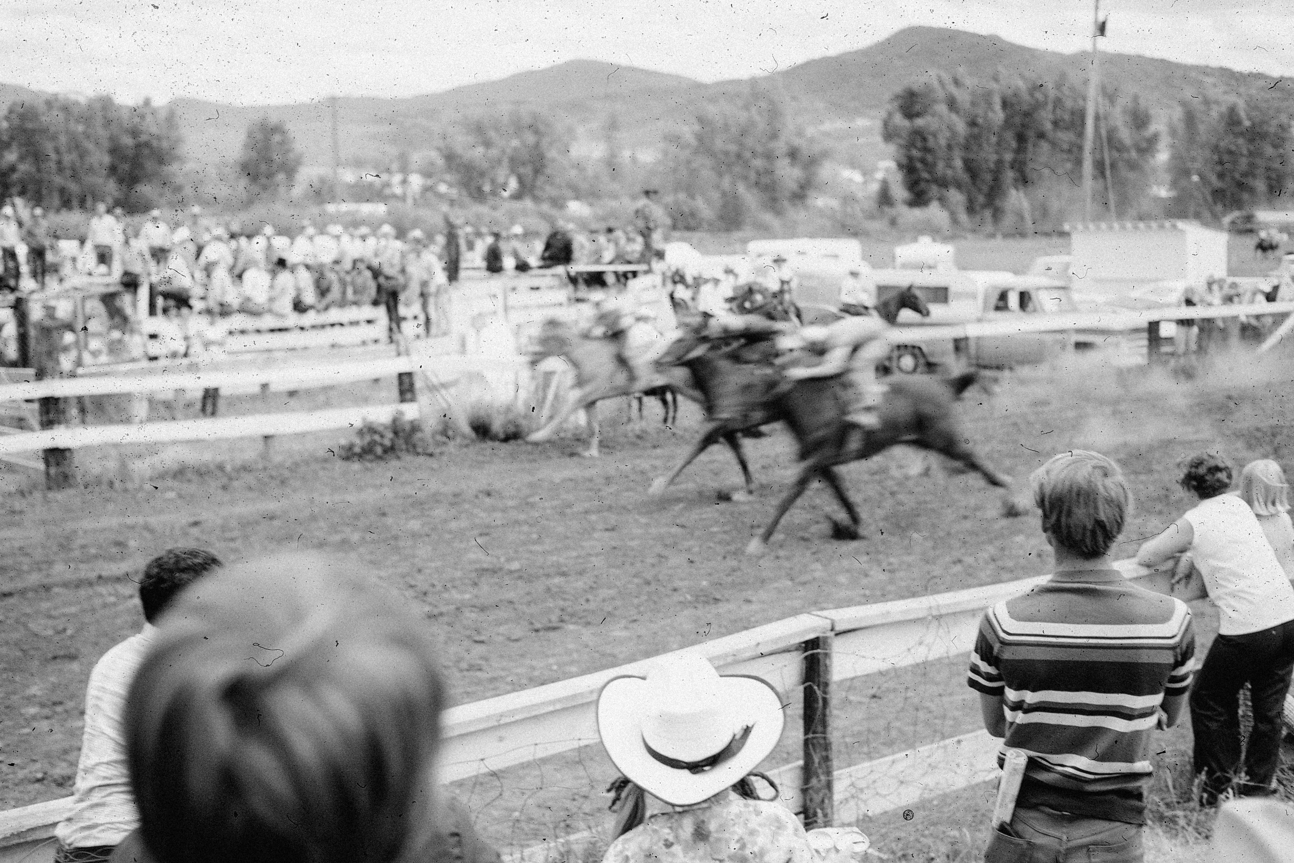 Horse race with spectators watching from the sidelines