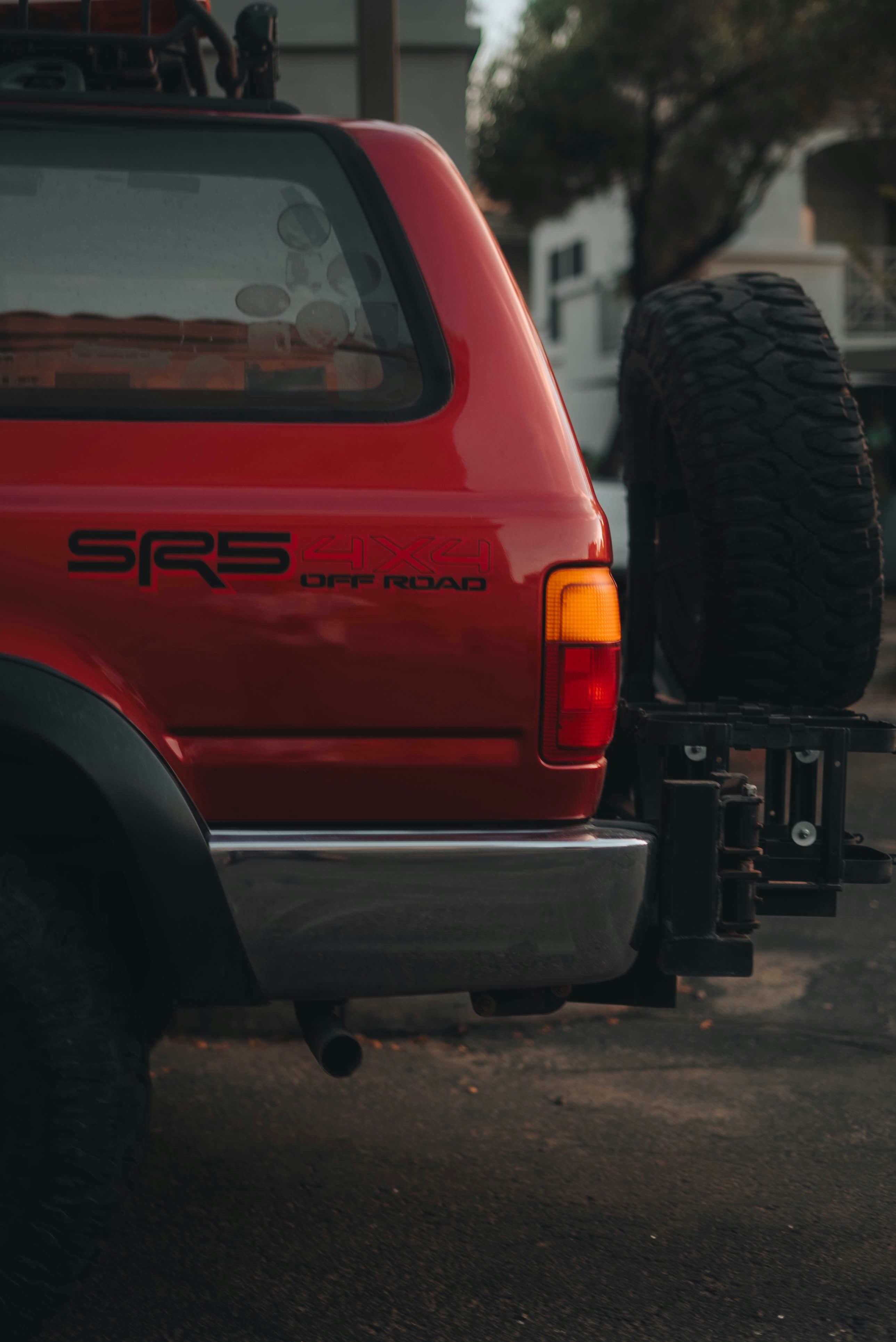 Red off-road vehicle with spare tire on back