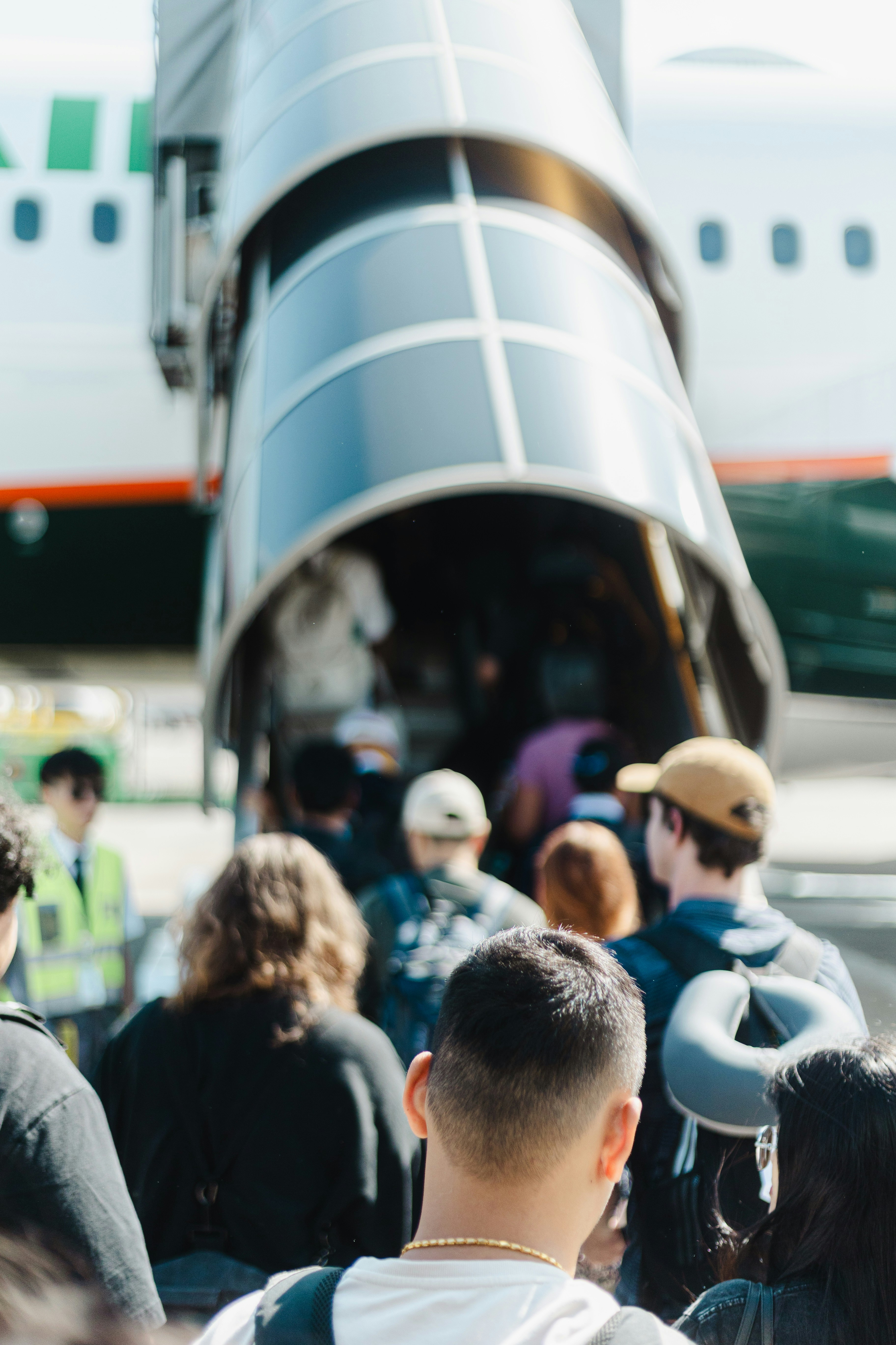 Passengers boarding an airplane via a jet bridge