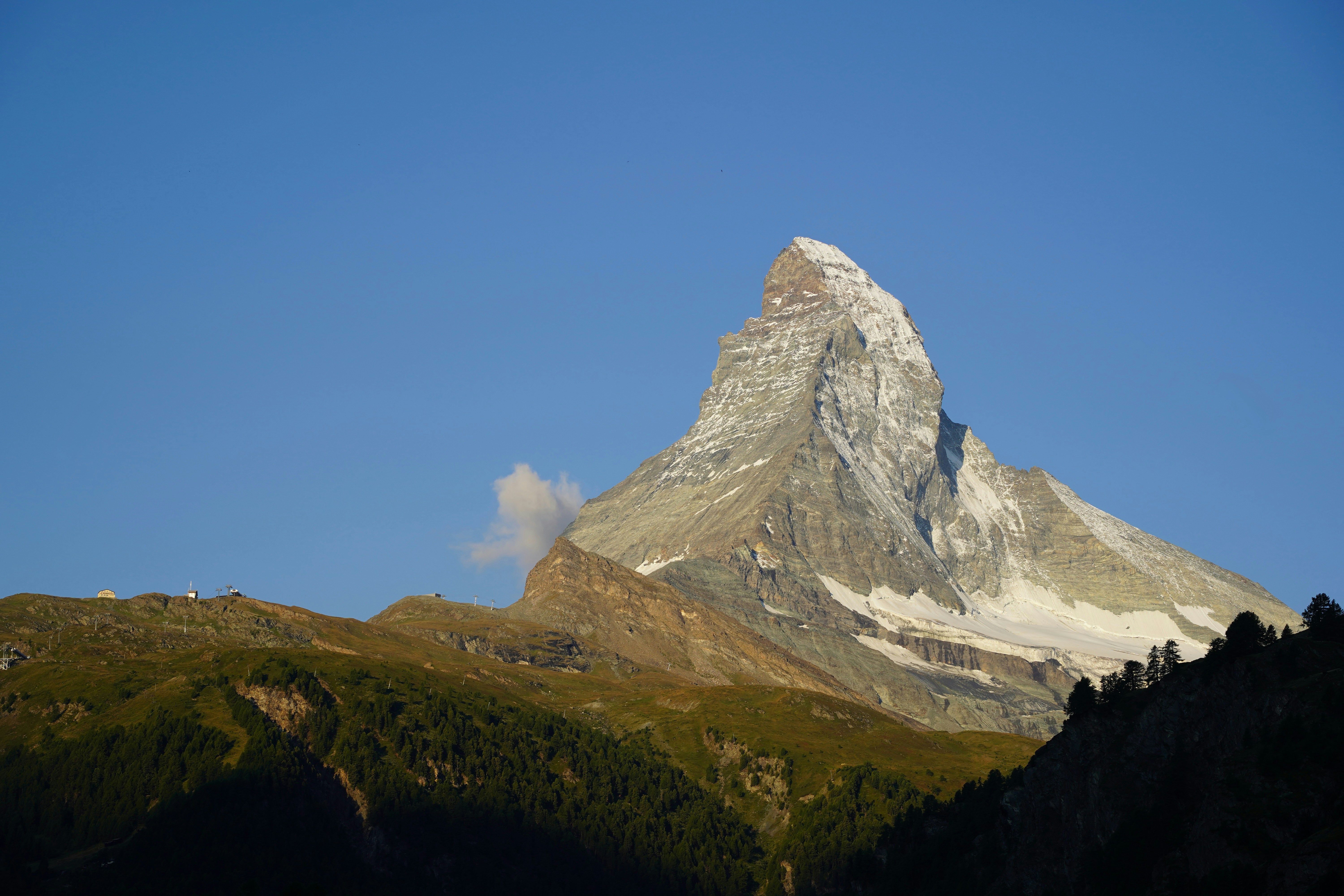 Majestic matterhorn peak against a clear blue sky.