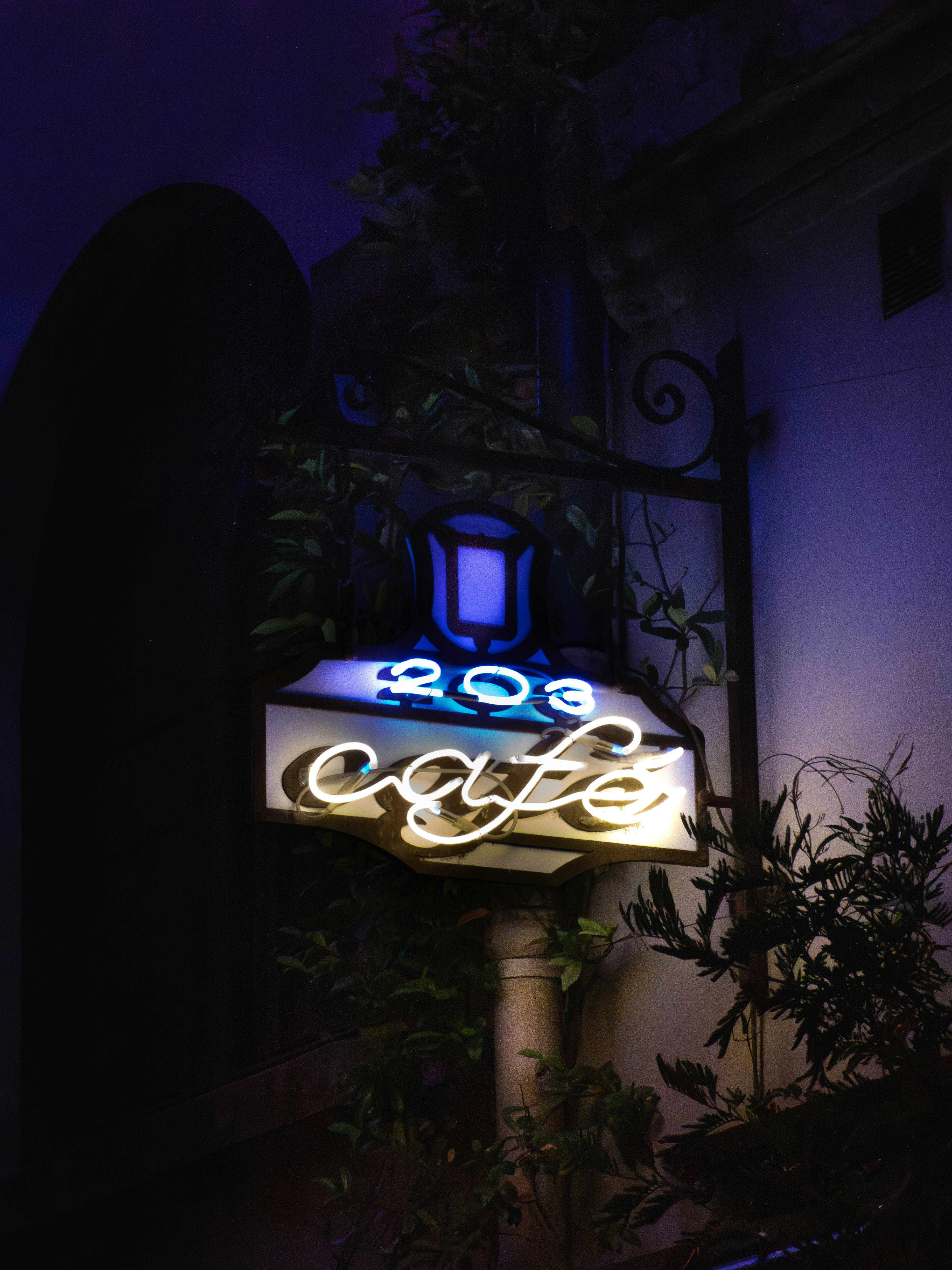 Neon cafe sign glowing at night