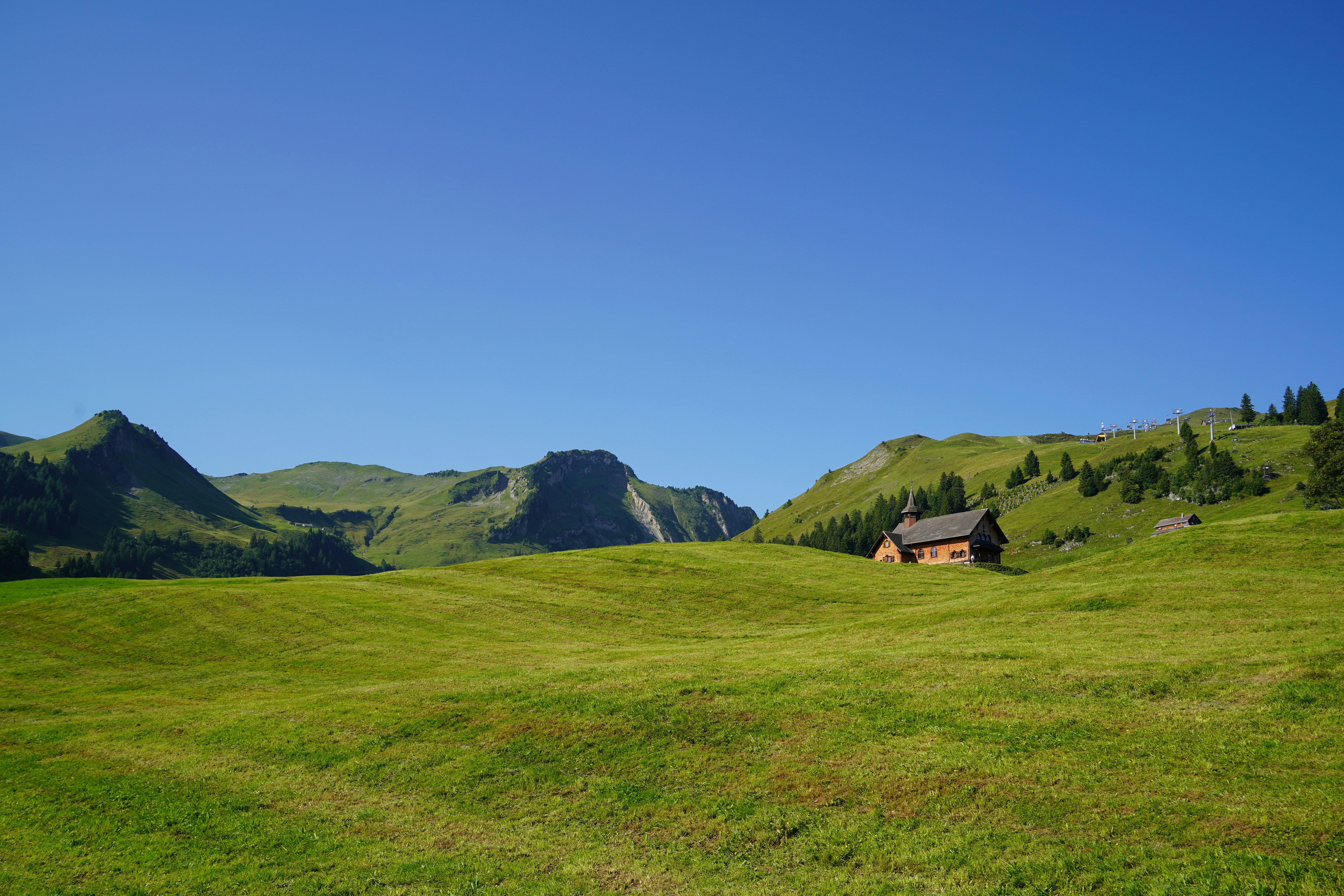 Small wooden cabin in a green mountain landscape