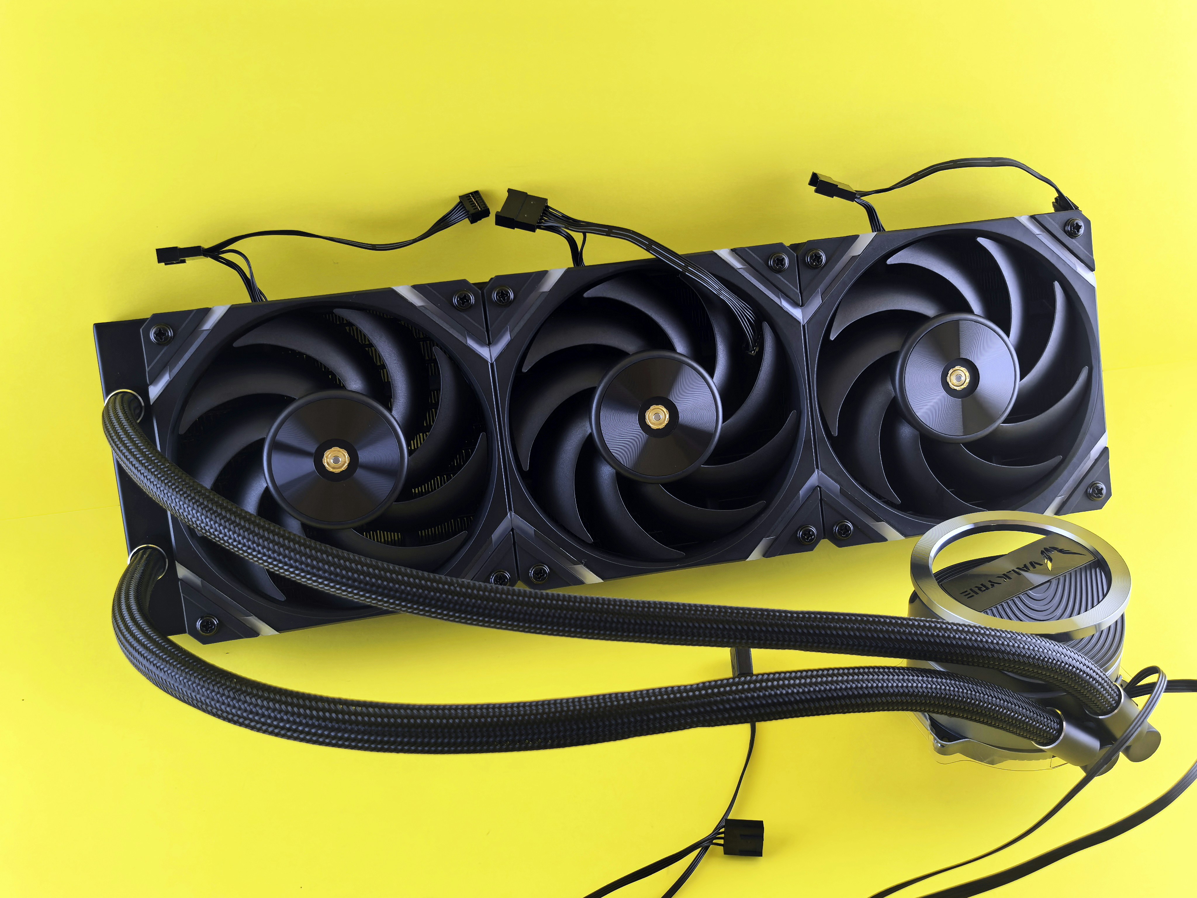 Black computer fan cooler with tubes on yellow background