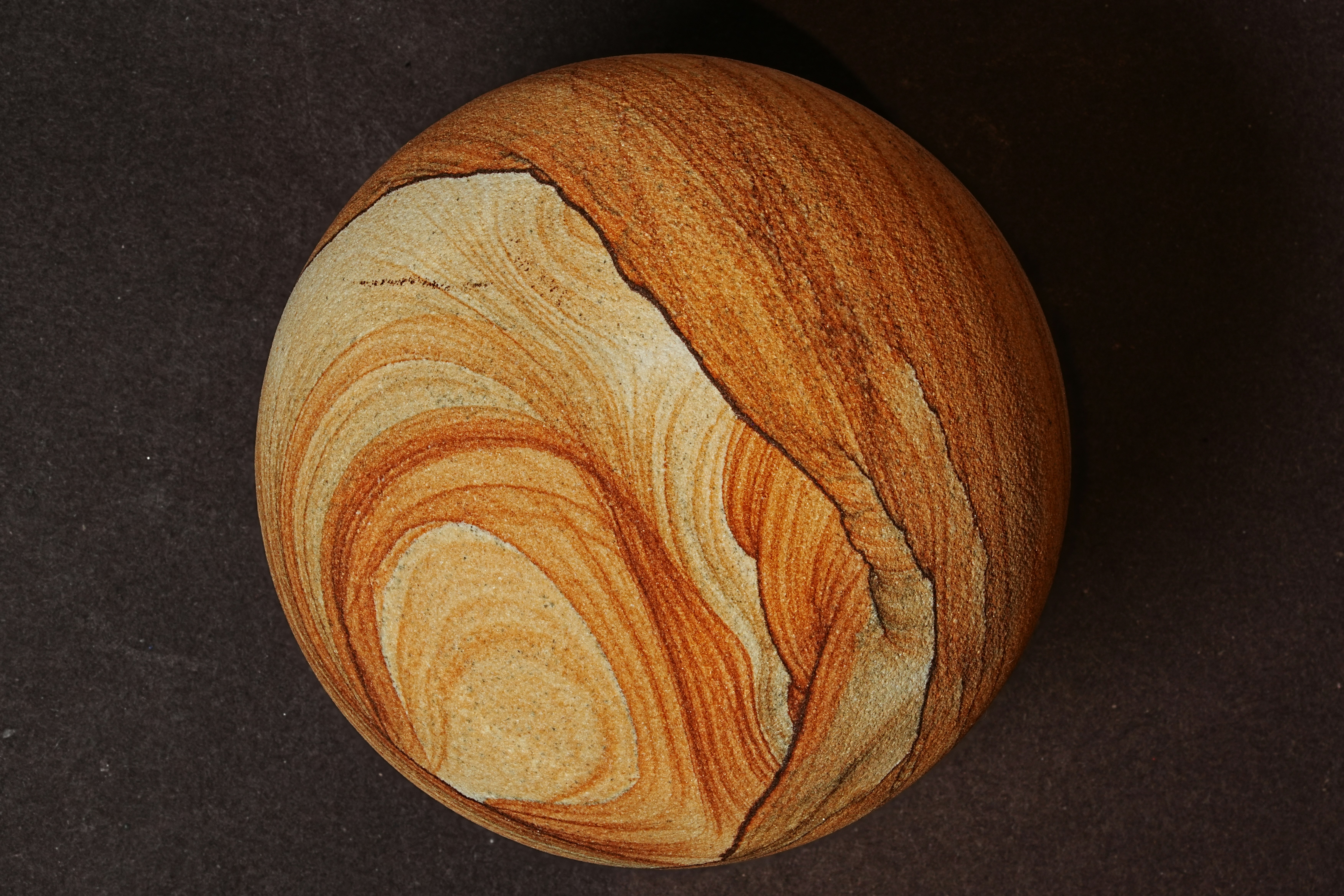 Round sandstone with natural swirling patterns