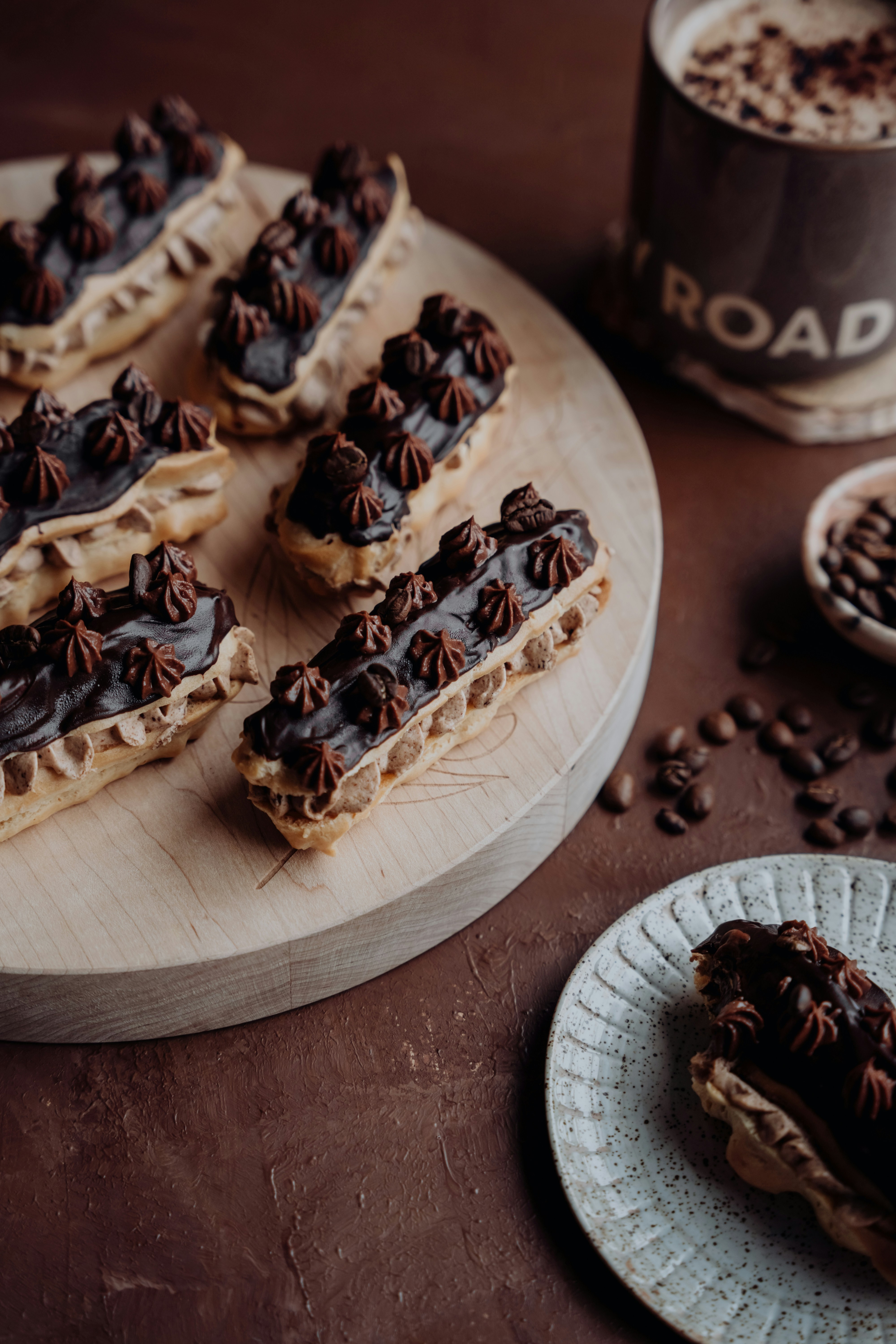 Chocolate eclairs with coffee and scattered beans