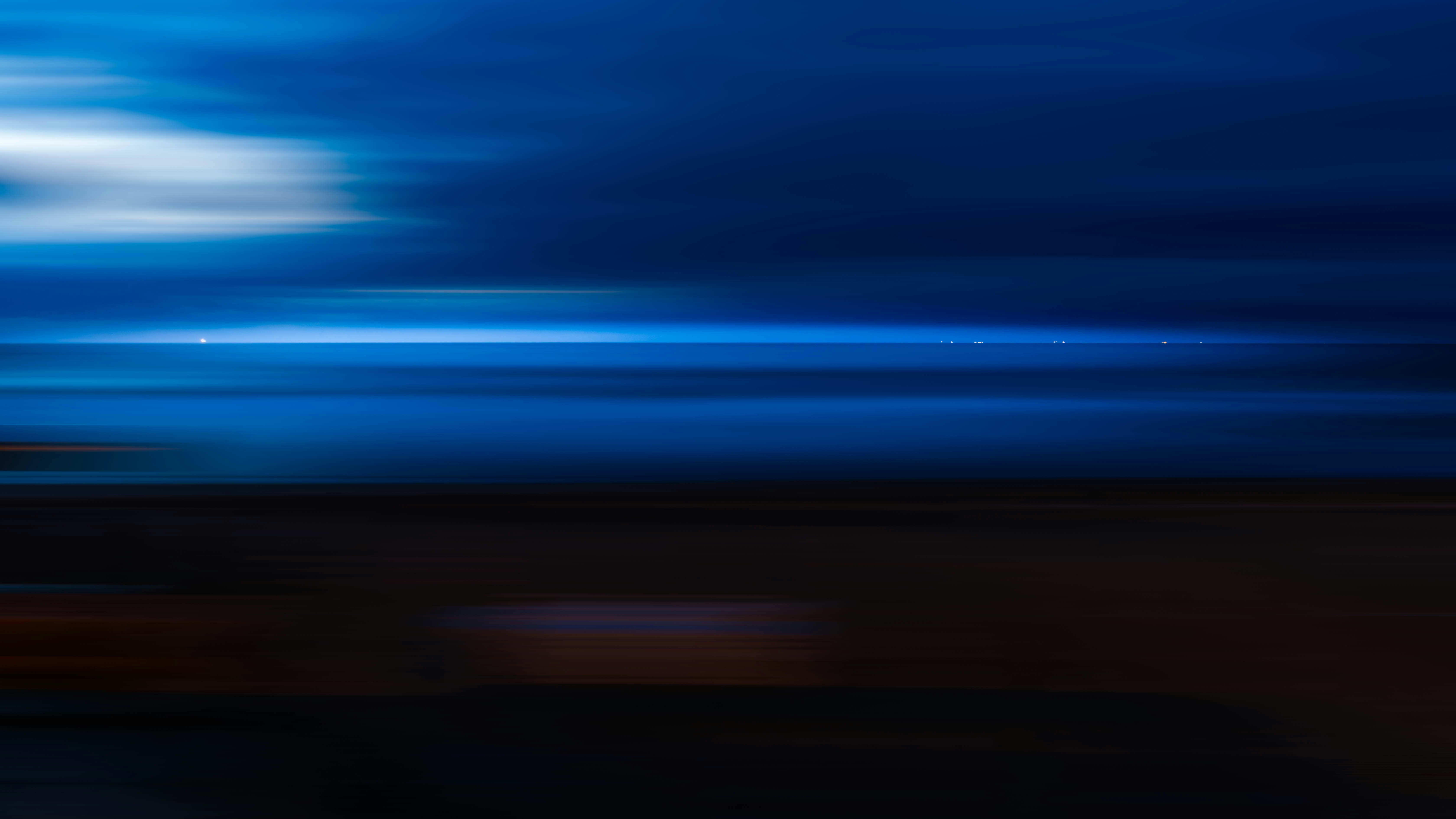 Abstract blue and dark background with light streaks