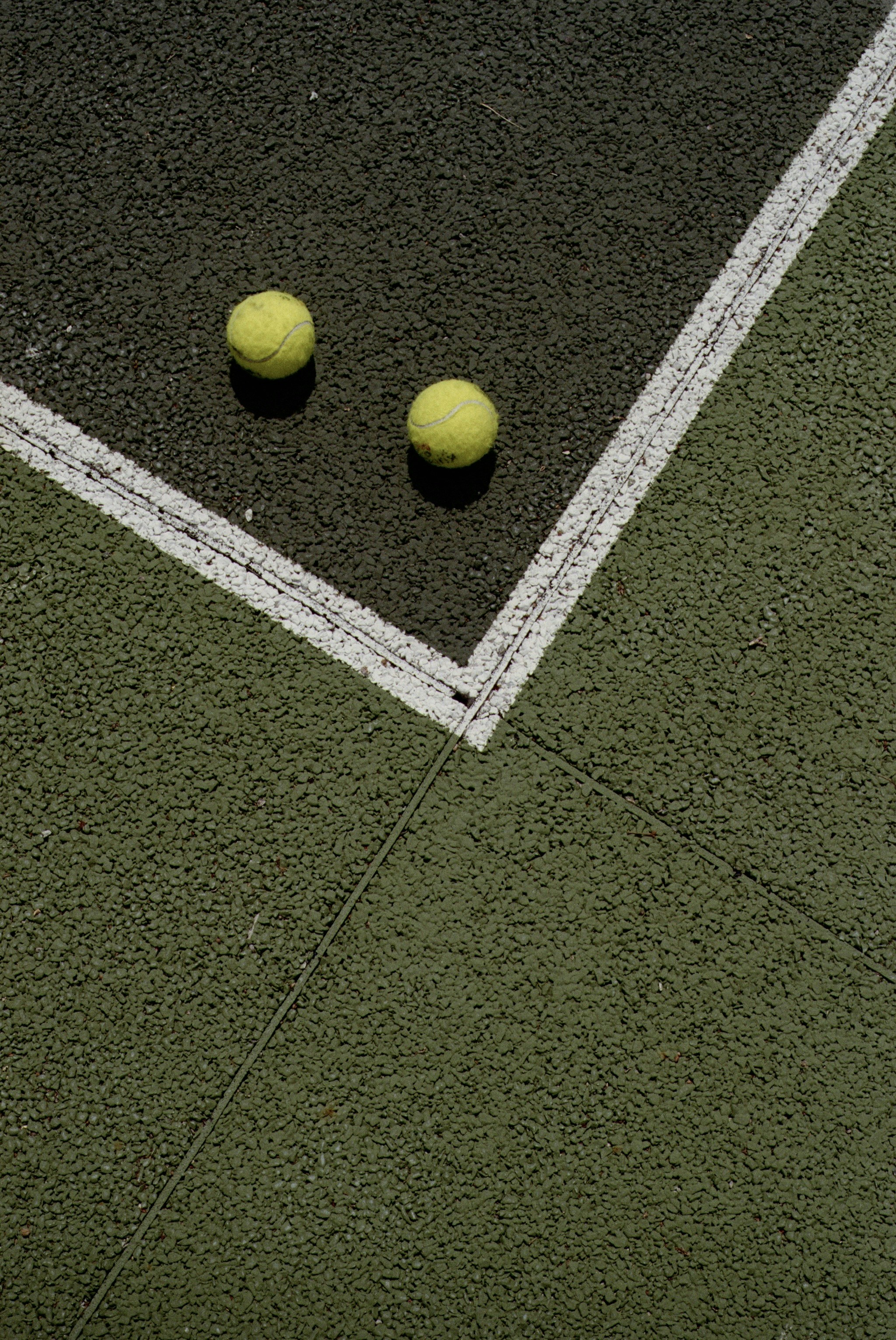 Two tennis balls on a court
