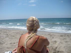 Woman with braided blonde hair on sandy beach
