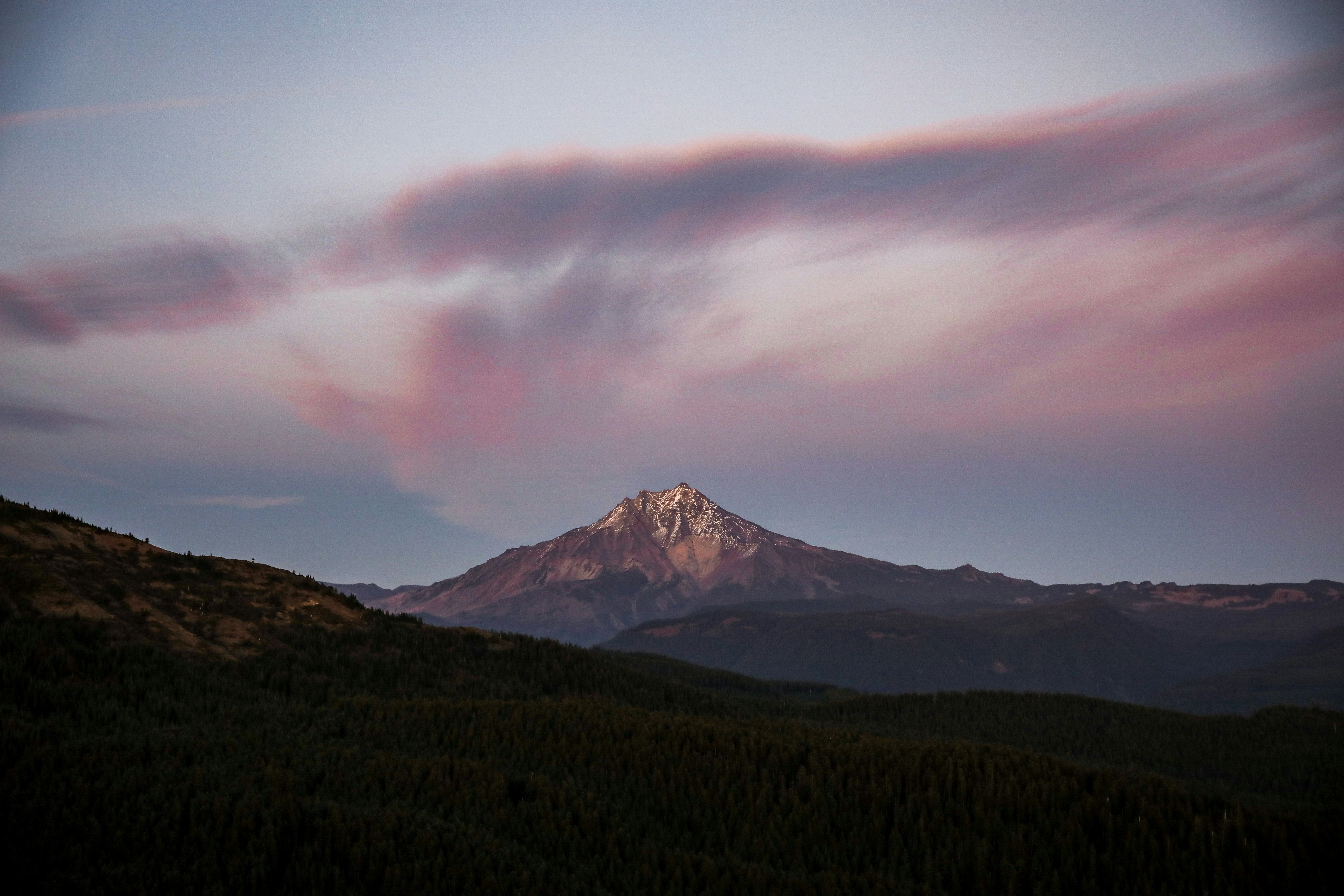 Majestic mountain peak bathed in soft sunset light