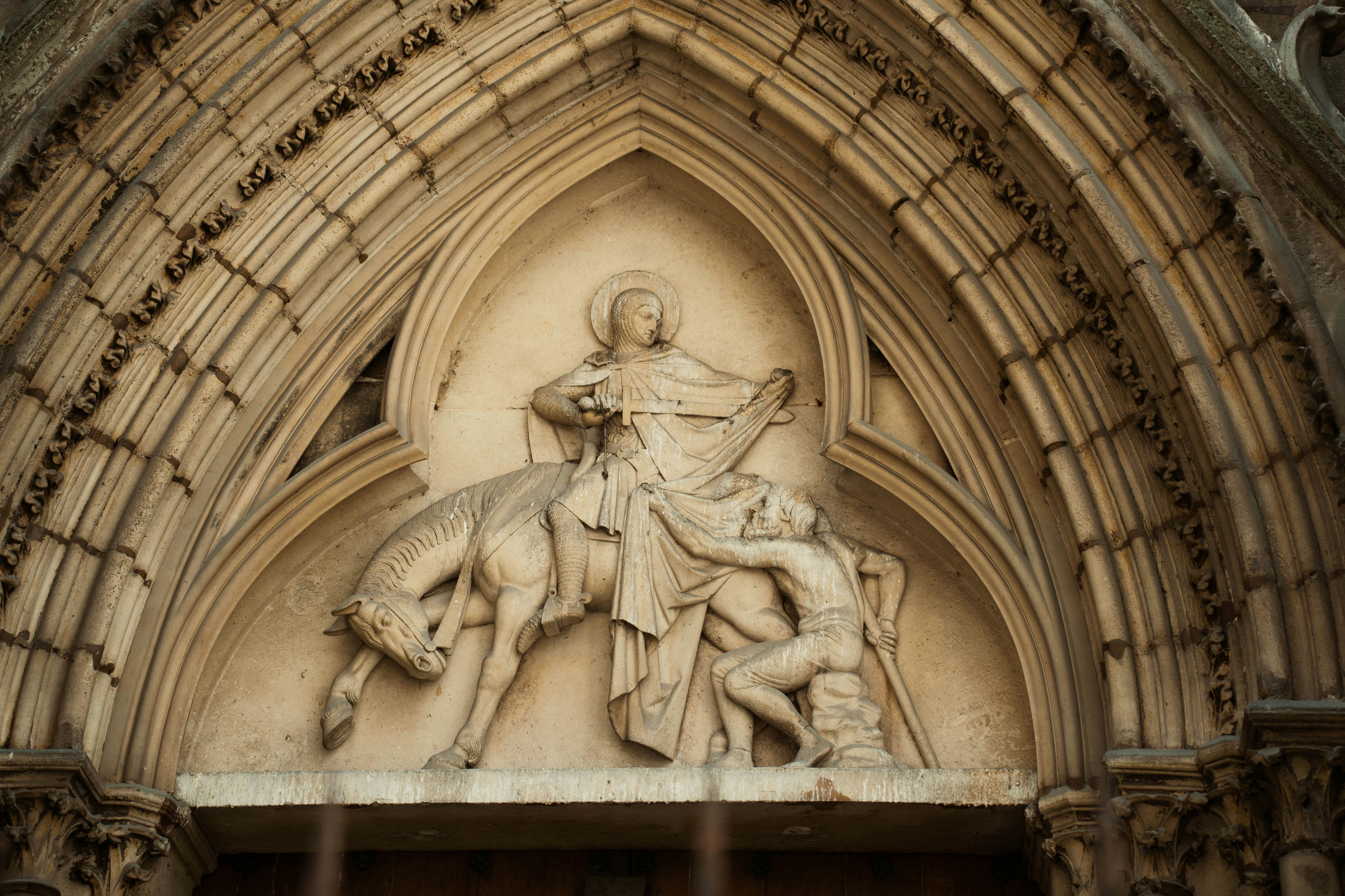 Stone relief of saint martin on horseback with beggar