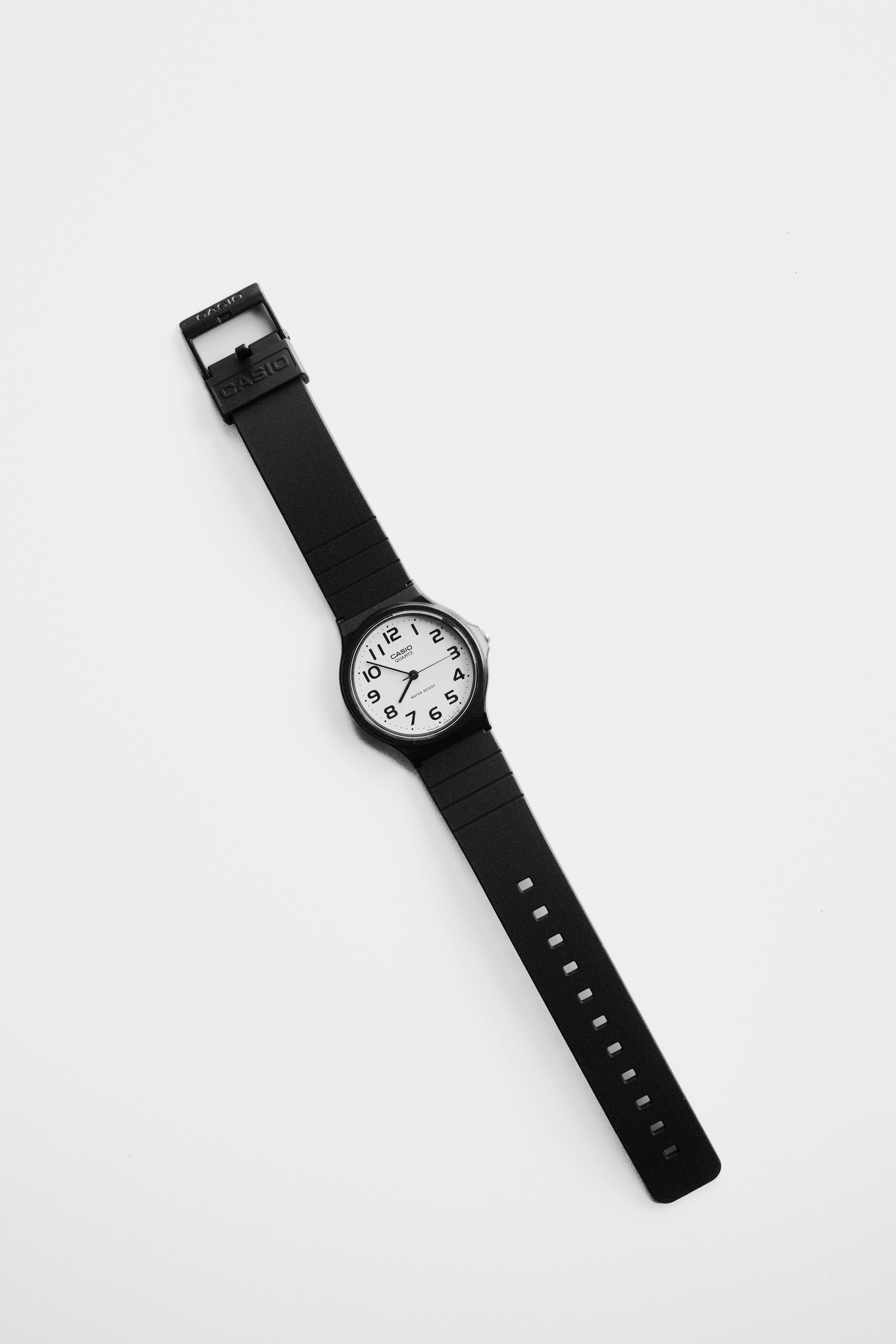 A black analog watch with a white face