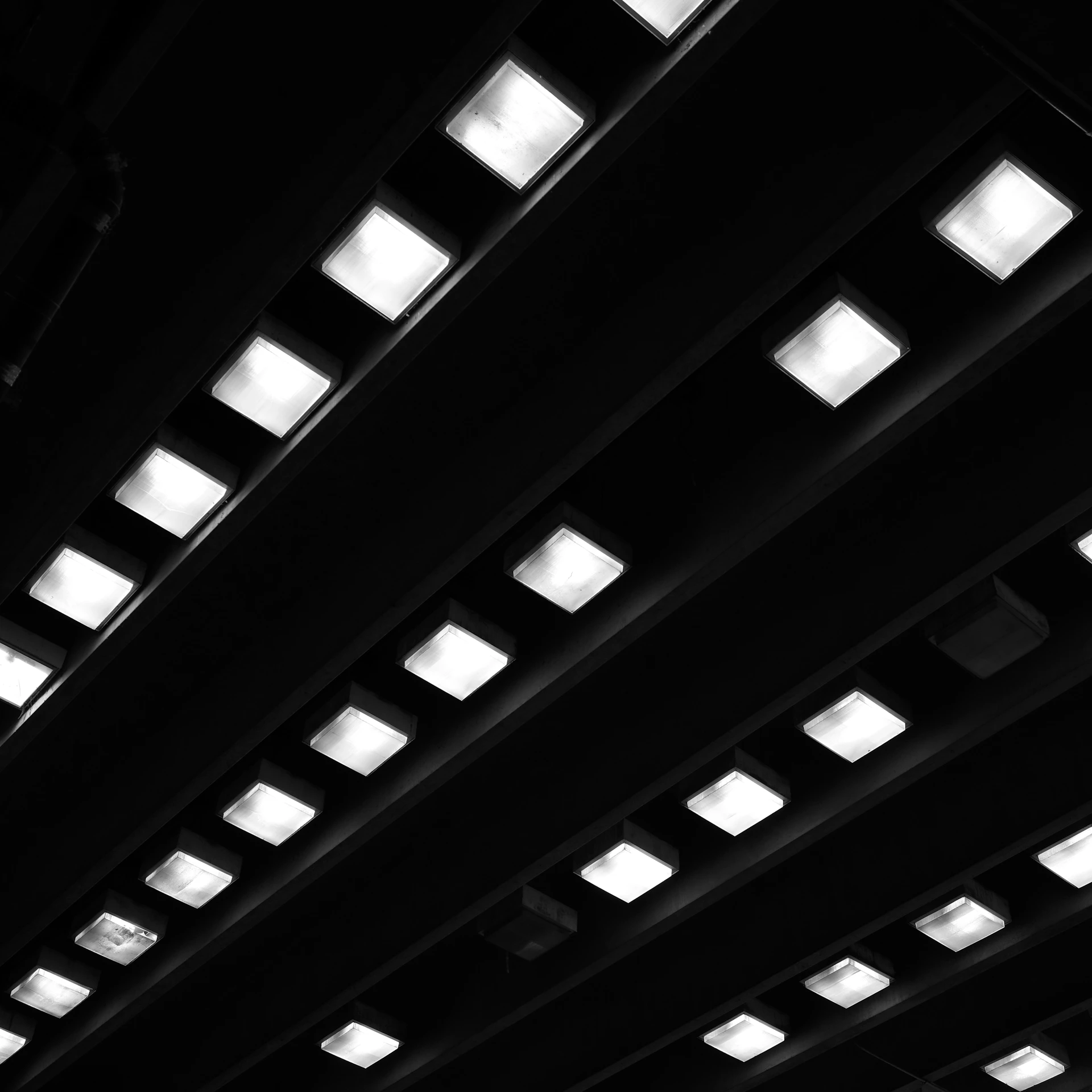 Rows of illuminated squares on a dark ceiling