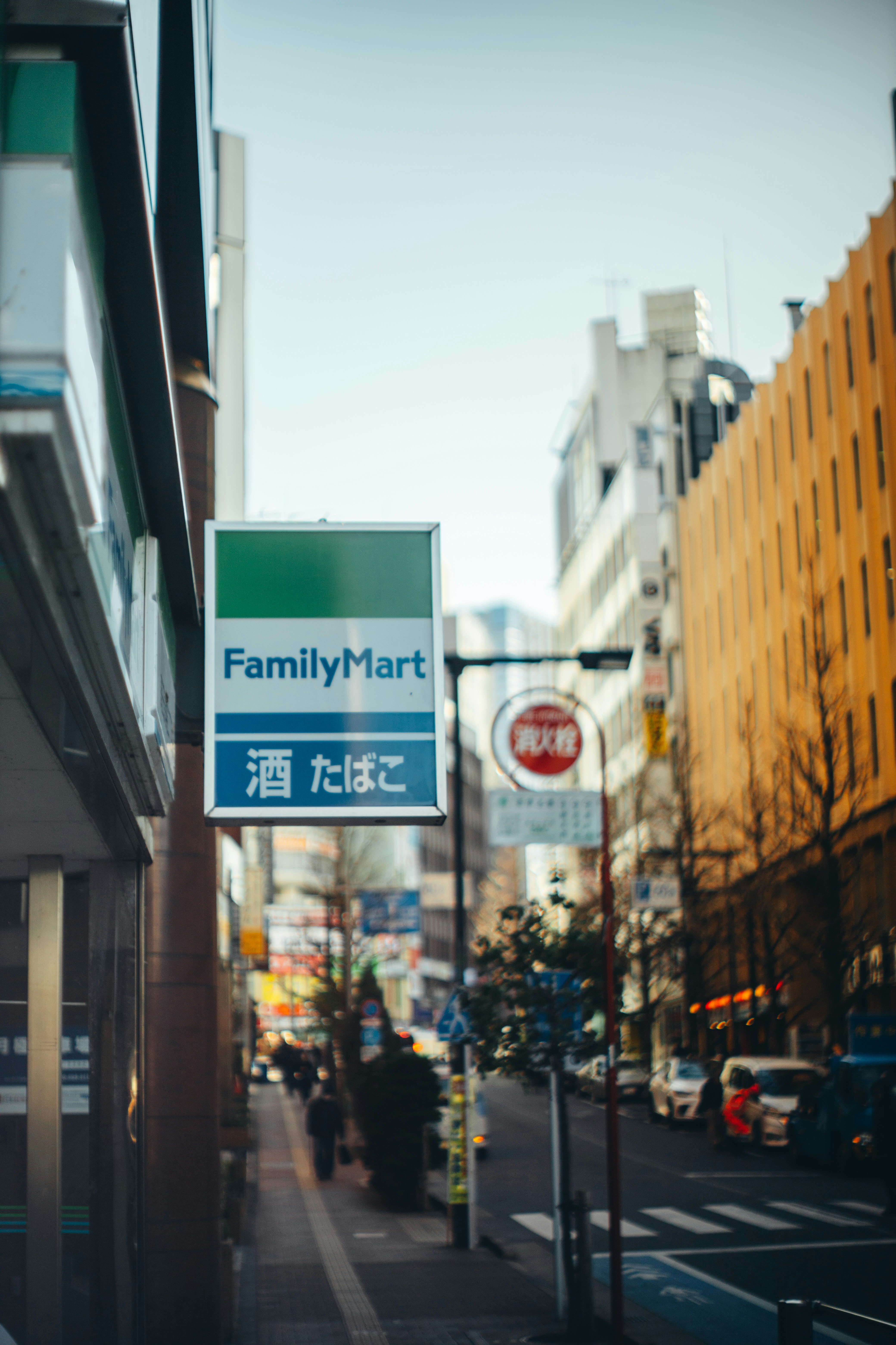 Familymart store sign on a city street.