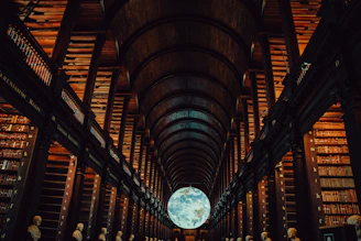 Grand library interior with a glowing globe