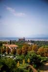 Tuscan village with trees and distant mountains