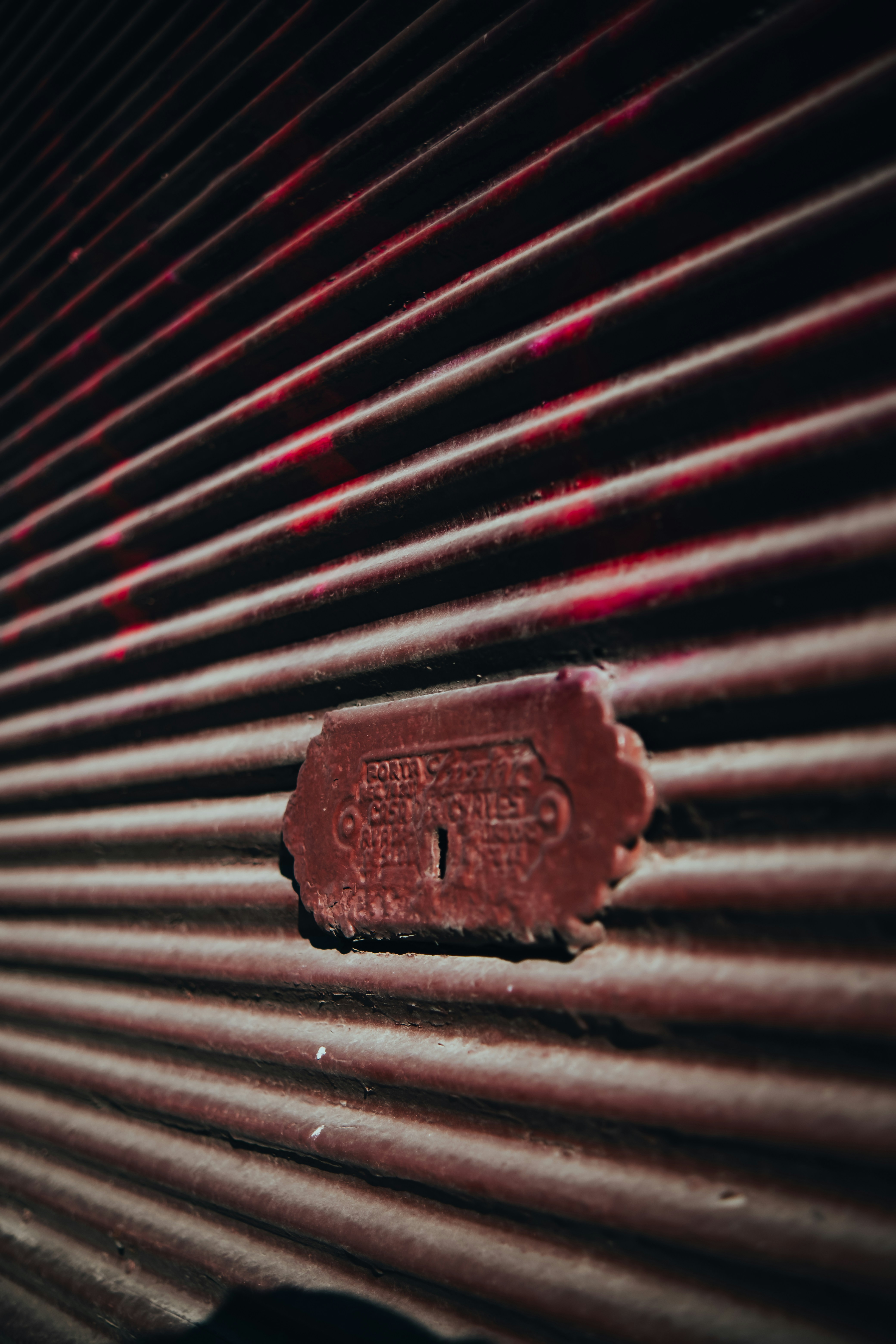 Close-up of a ribbed metal surface with a tag.