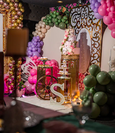A festive party setup with balloons, cake, and decorations