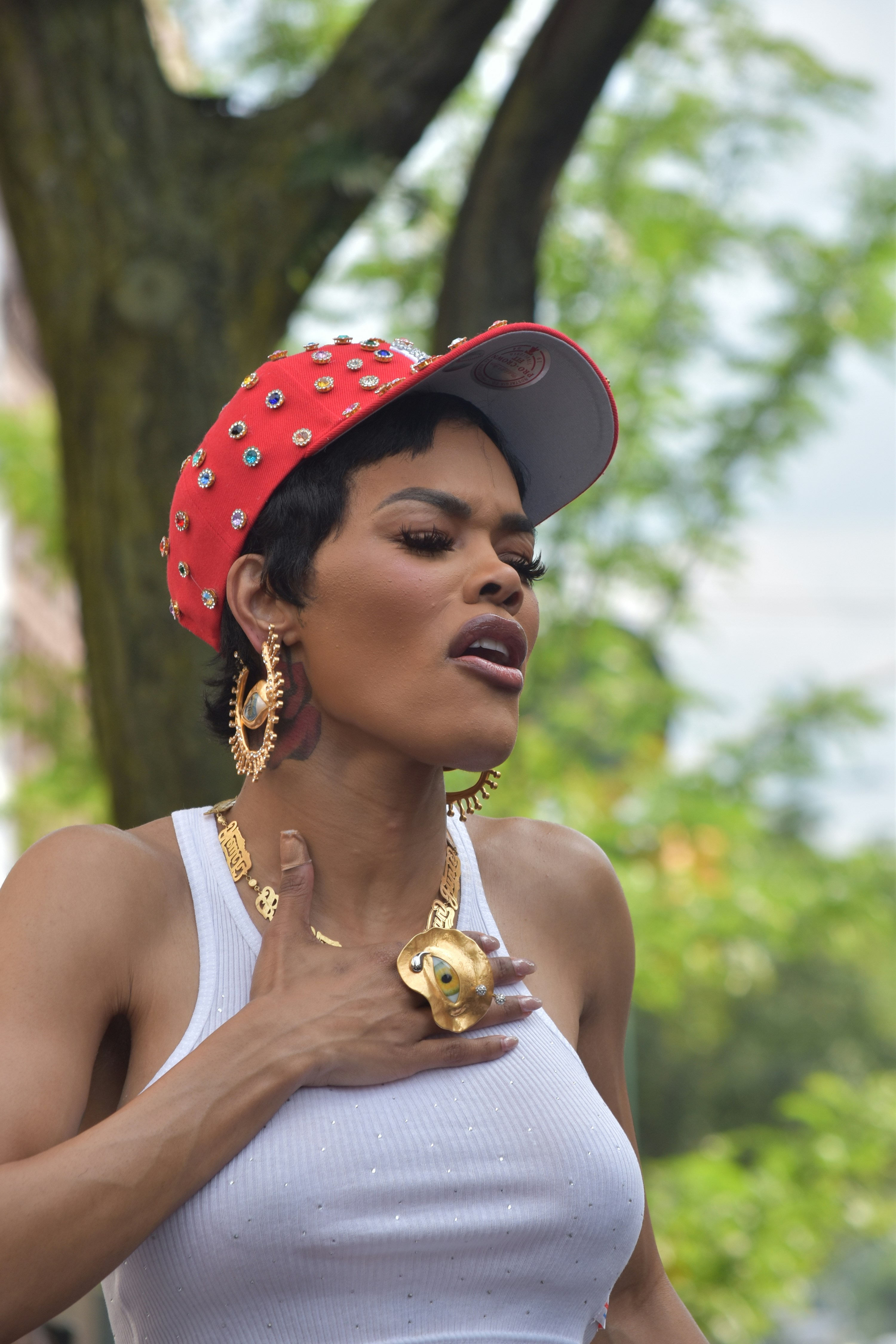 Woman in red hat and white tank top