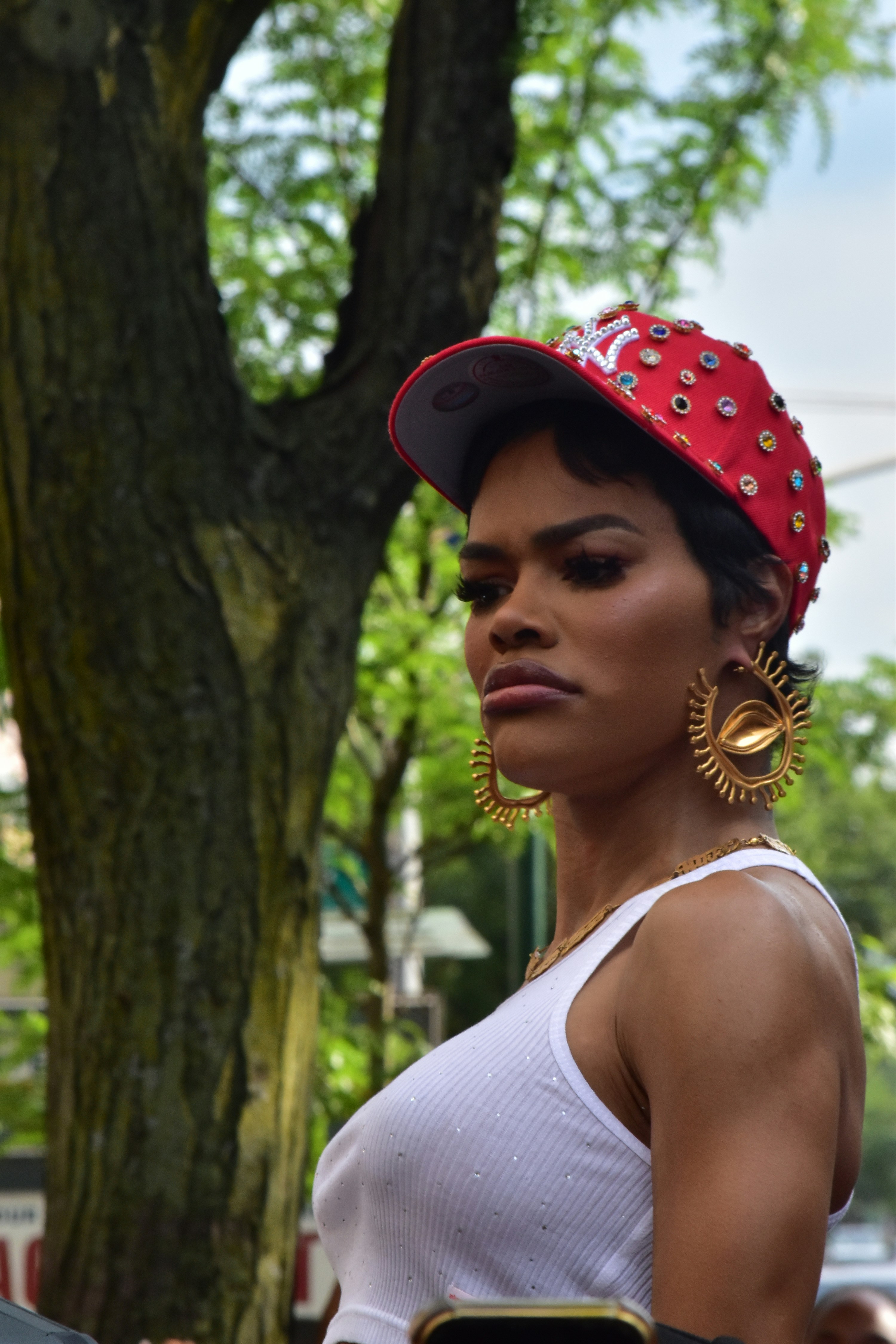 Woman with red hat and large earrings