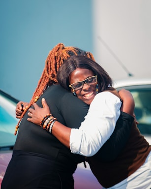 Two women embracing with smiles