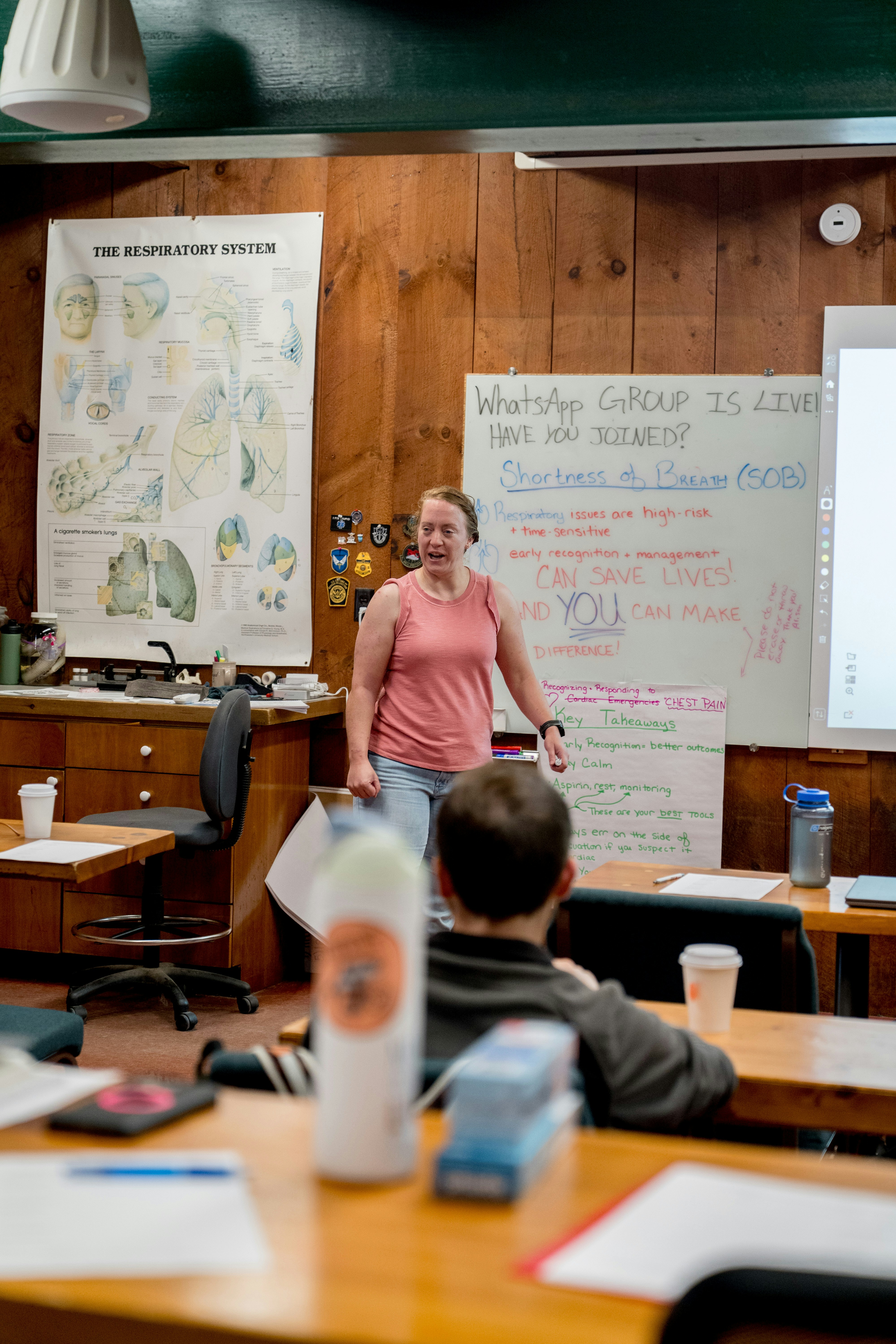 Teacher leading class discussion near whiteboard