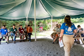 Group listening to presenter under a tent