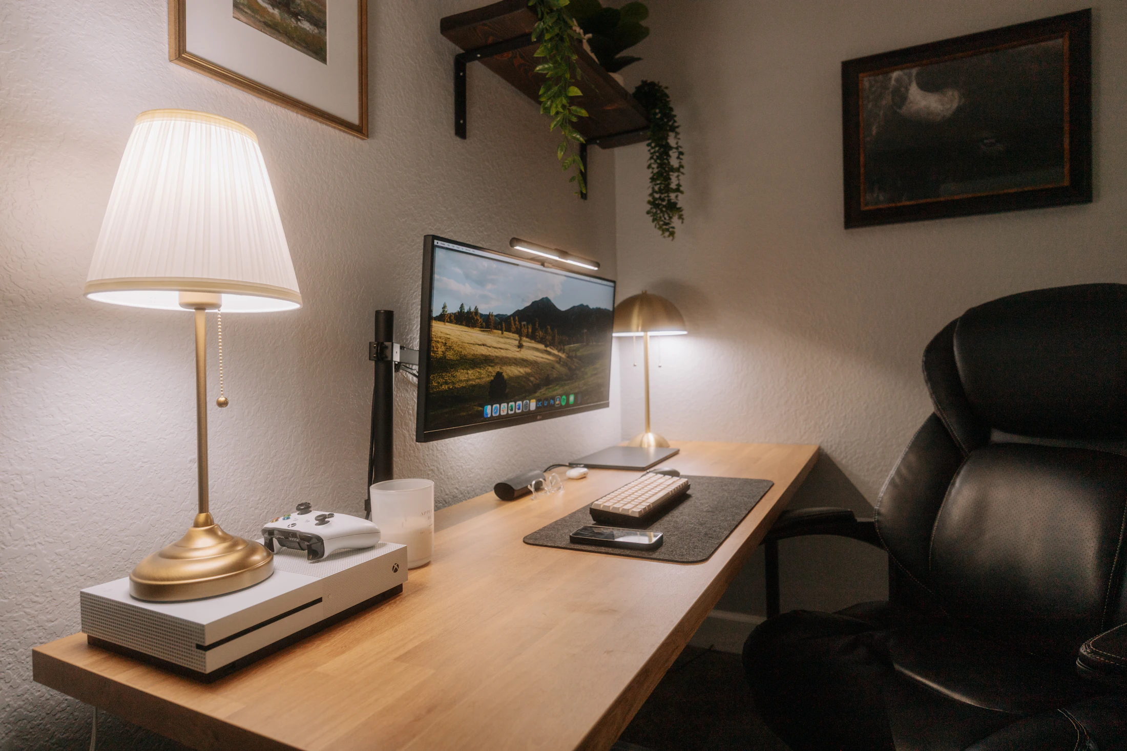 Modern desk with monitor arm, ergonomic chair, keyboard, and multiple task lamps