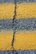 Close-up of yellow lines on asphalt road