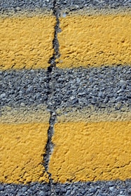 Close-up of yellow lines on asphalt road
