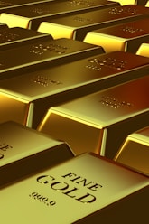 Rows of shiny gold bars with "fine gold" markings