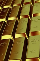 Rows of shiny gold bars stacked neatly.