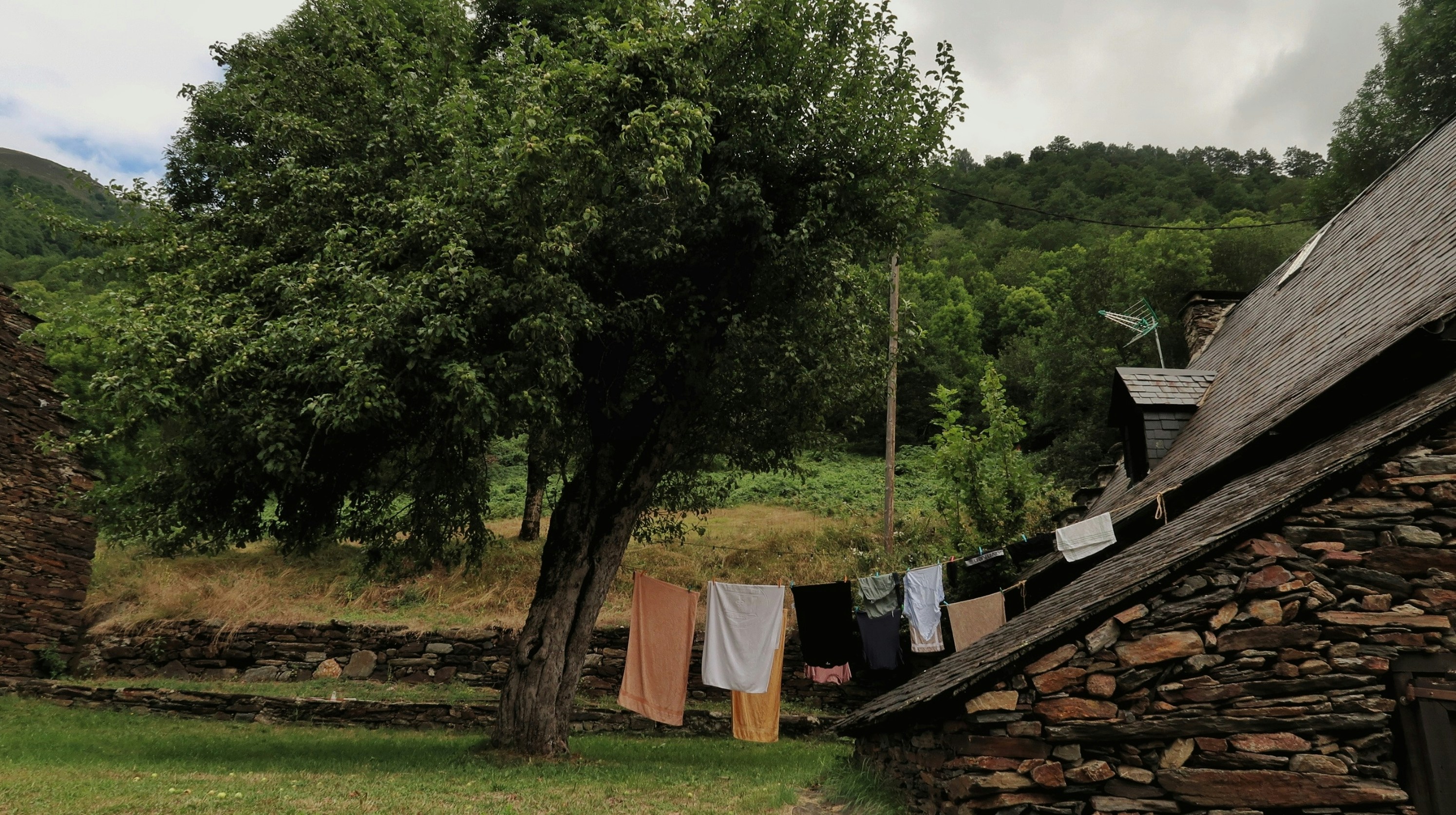 Digital nomad working on a laptop with a view of a Spanish city, symbolizing the new Spain-UK visa proposal.